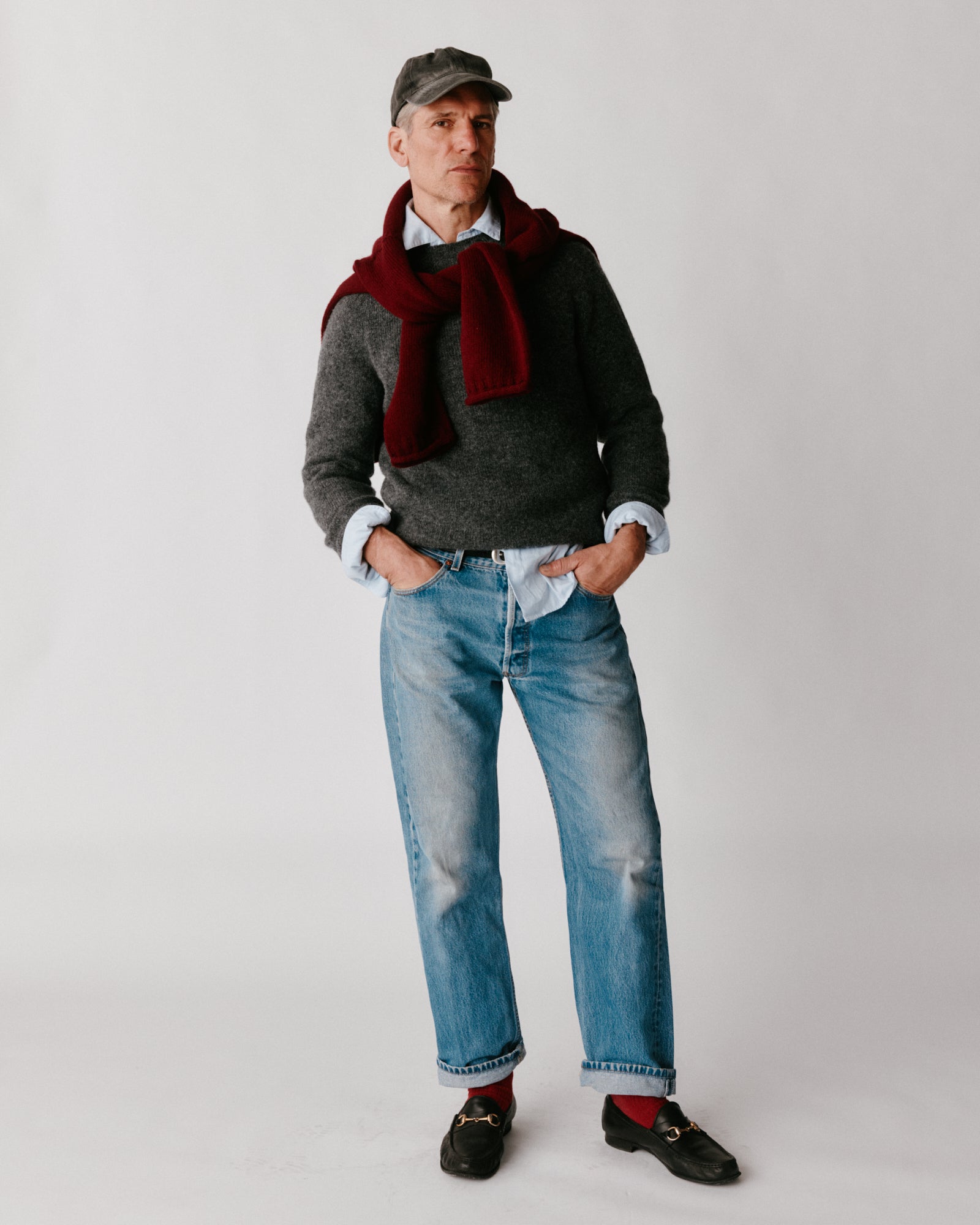 A model wearing a Bosie Harley of Scotland Mens Seamless Saddle Shoulder Shetland Sweater in colour Basalt / Oxford Grey.