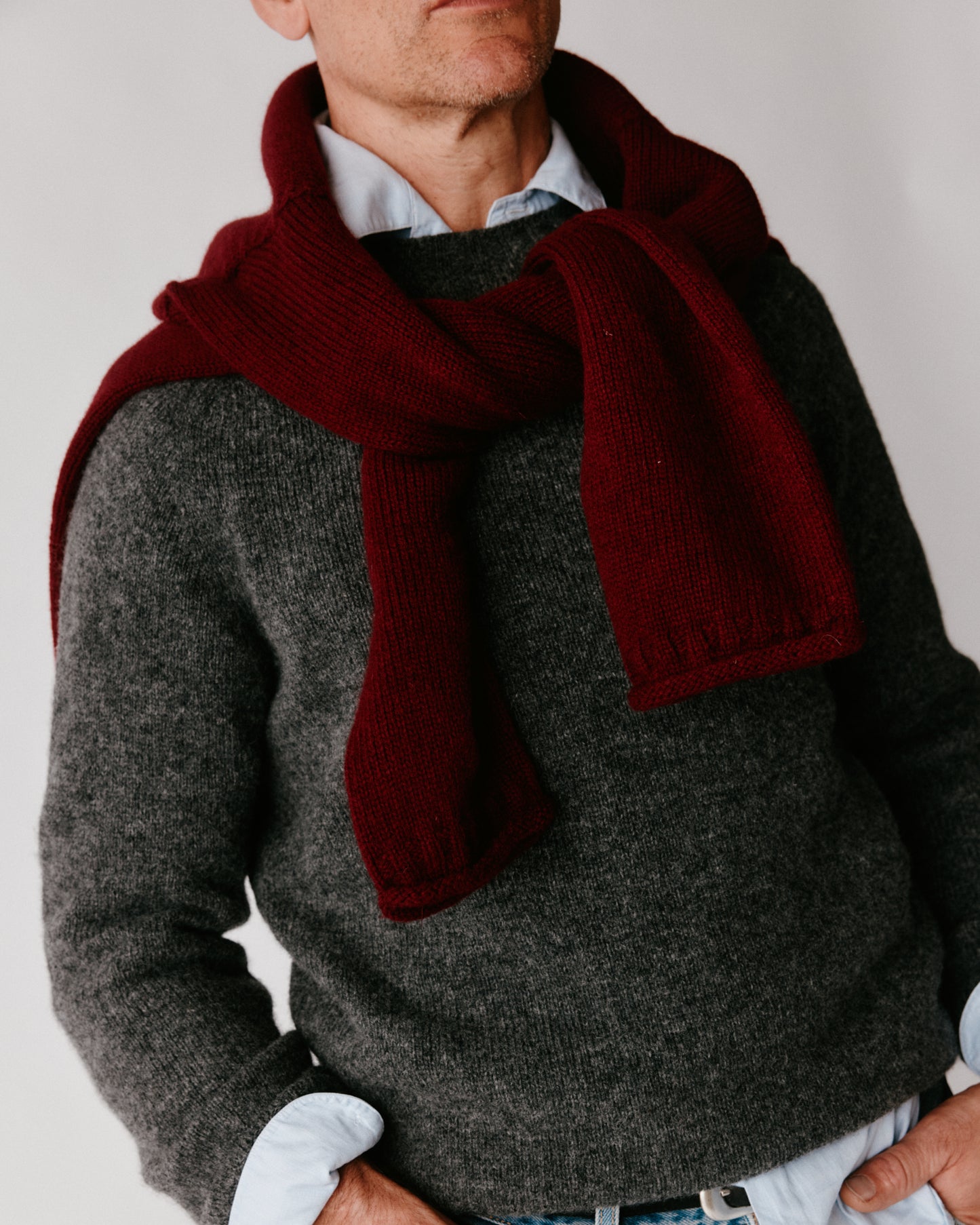 A model wearing a Bosie Harley of Scotland Mens Seamless Saddle Shoulder Shetland Sweater in colour Basalt / Oxford Grey.