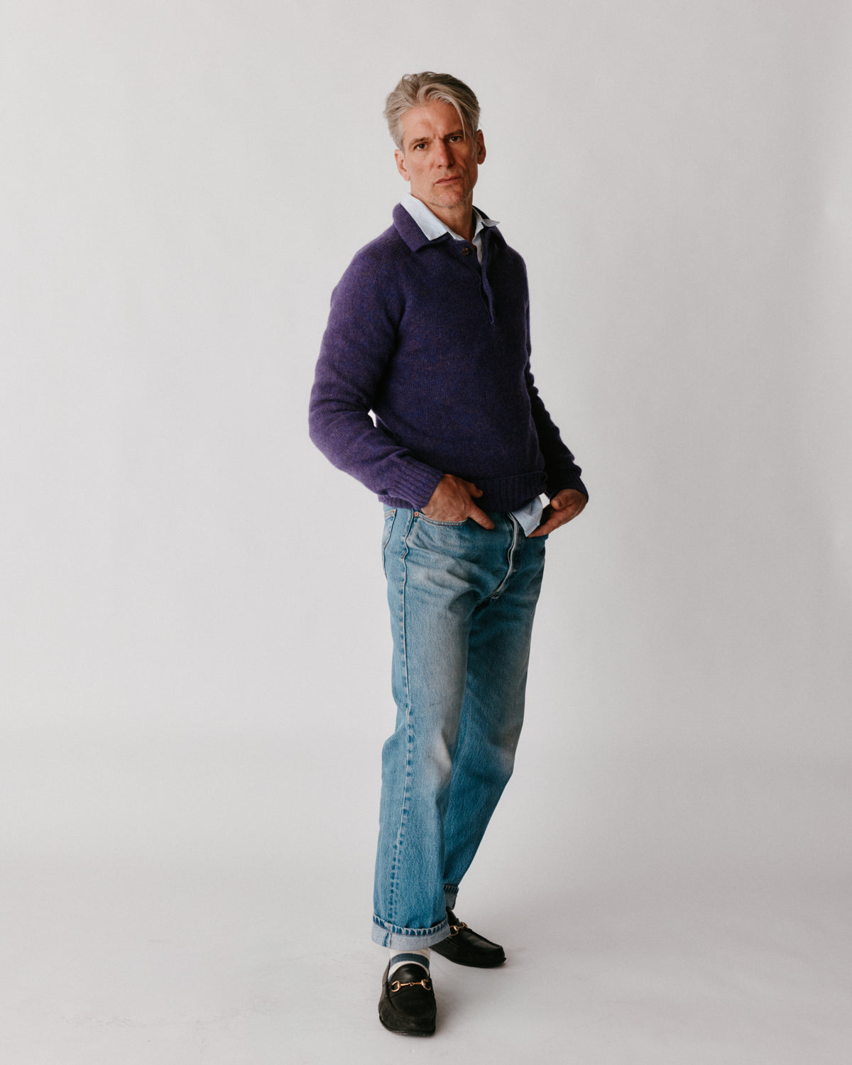 A model wearing a Bosie Harley of Scotland Mens Shetland Eton Collar Sweater in colour Iris / Royal Violet.