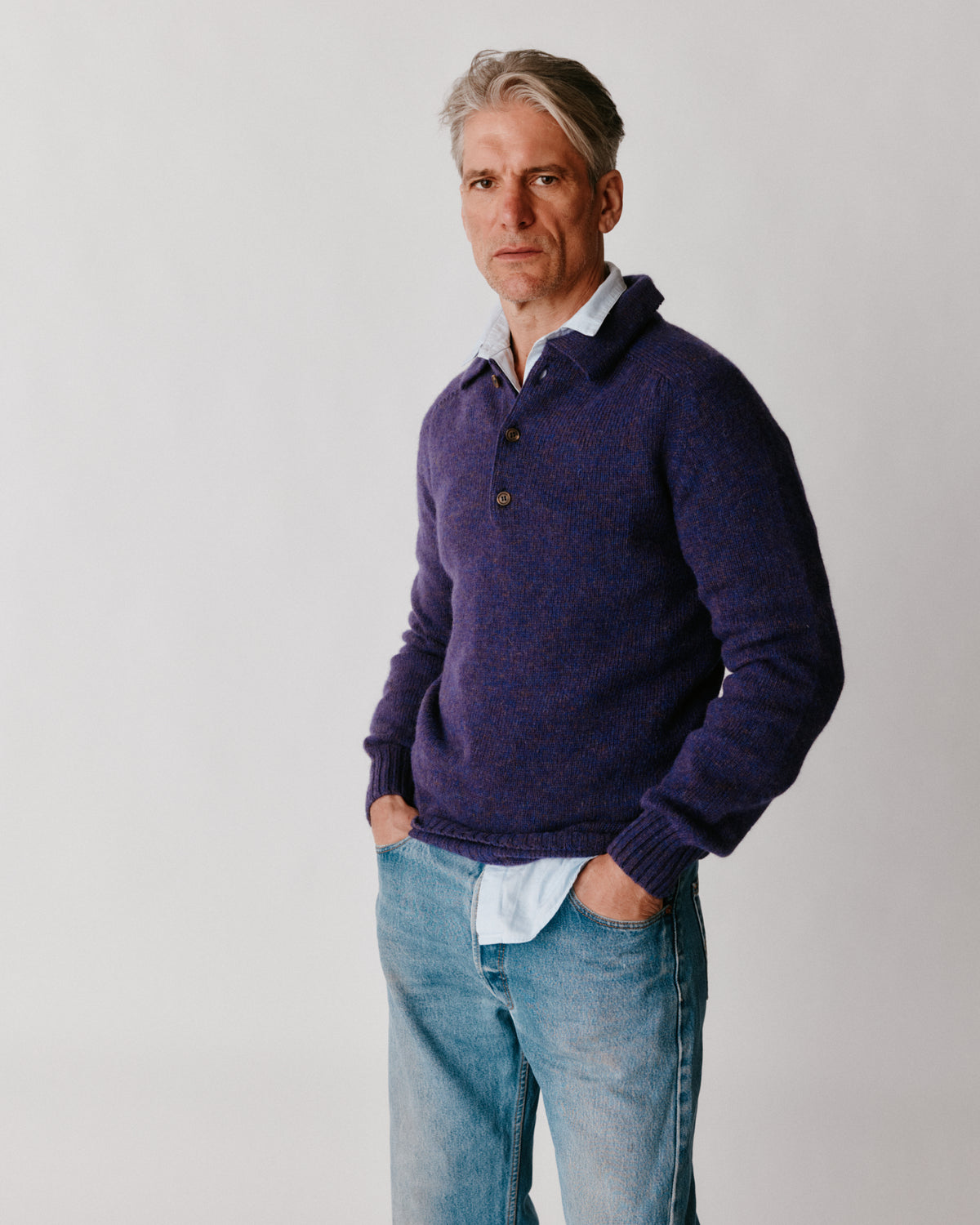 A model wearing a Bosie Harley of Scotland Mens Shetland Eton Collar Sweater in colour Iris / Royal Violet.