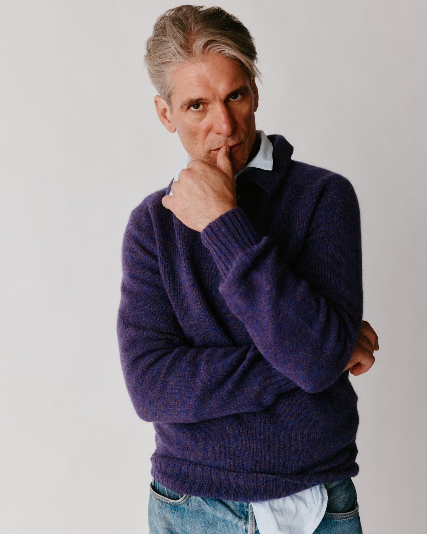 A model wearing a Bosie Harley of Scotland Mens Shetland Eton Collar Sweater in colour Iris / Royal Violet.