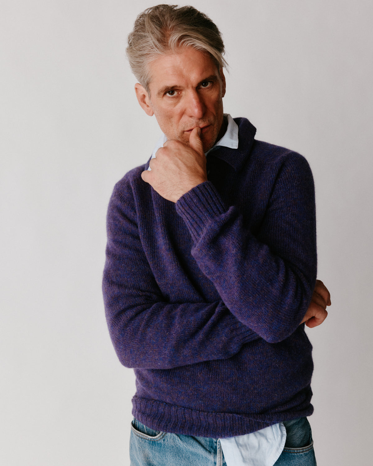 A model wearing a Bosie Harley of Scotland Mens Shetland Eton Collar Sweater in colour Iris / Royal Violet.
