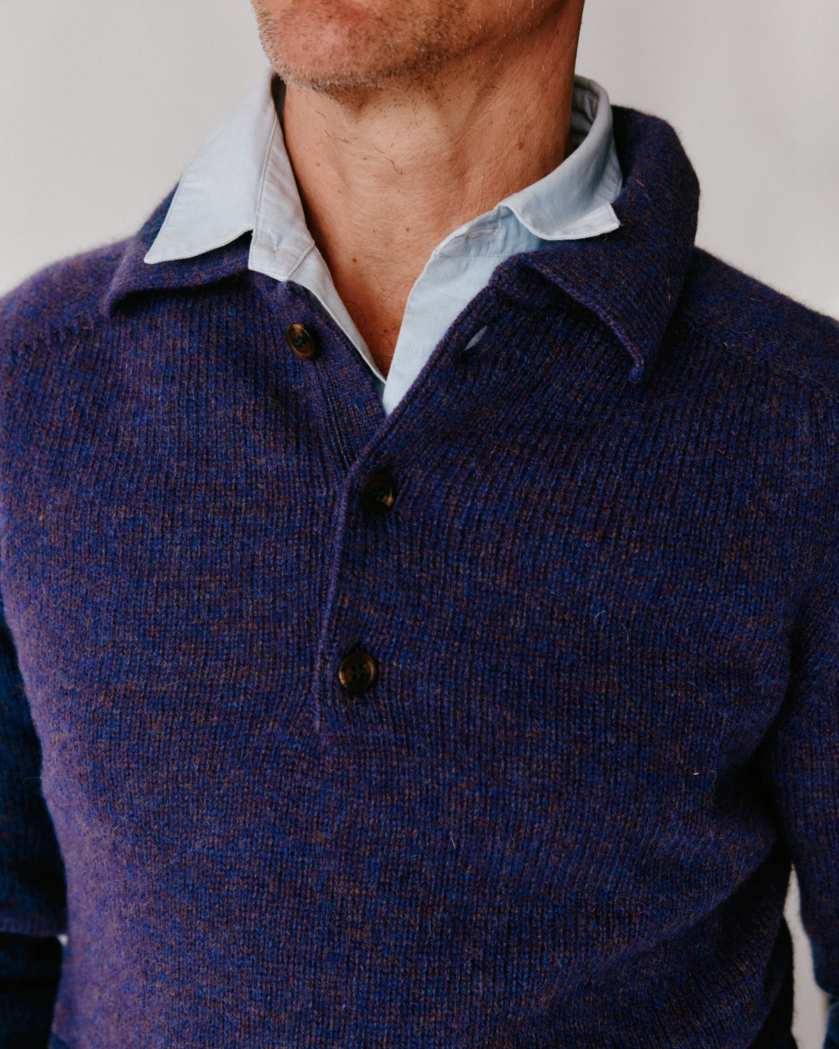 A model wearing a Bosie Harley of Scotland Mens Shetland Eton Collar Sweater in colour Iris / Royal Violet.