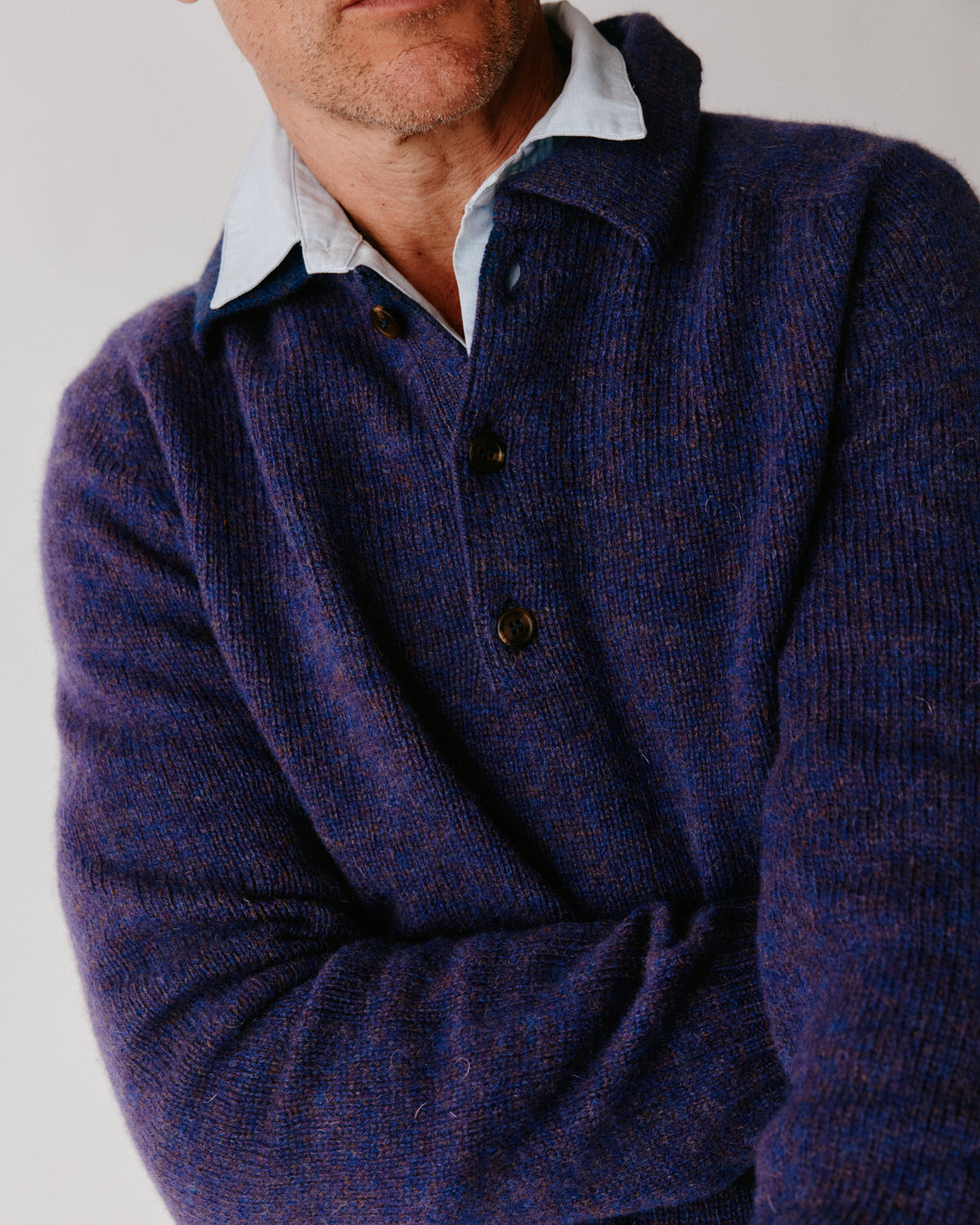 A model wearing a Bosie Harley of Scotland Mens Shetland Eton Collar Sweater in colour Iris / Royal Violet.