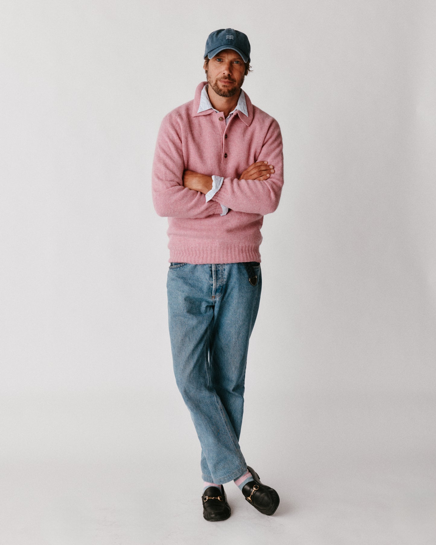 A model wearing a Bosie Harley of Scotland Mens Shetland Eton Collar Sweater in colour Sakura / Bosie Pink.