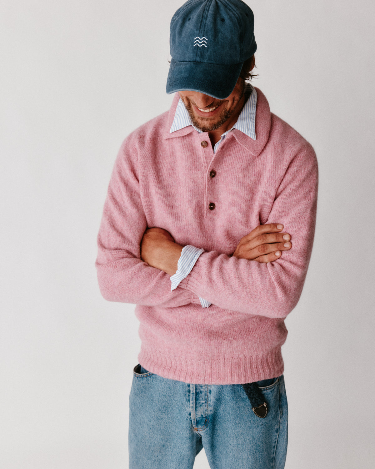 A model wearing a Bosie Harley of Scotland Mens Shetland Eton Collar Sweater in colour Sakura / Bosie Pink.