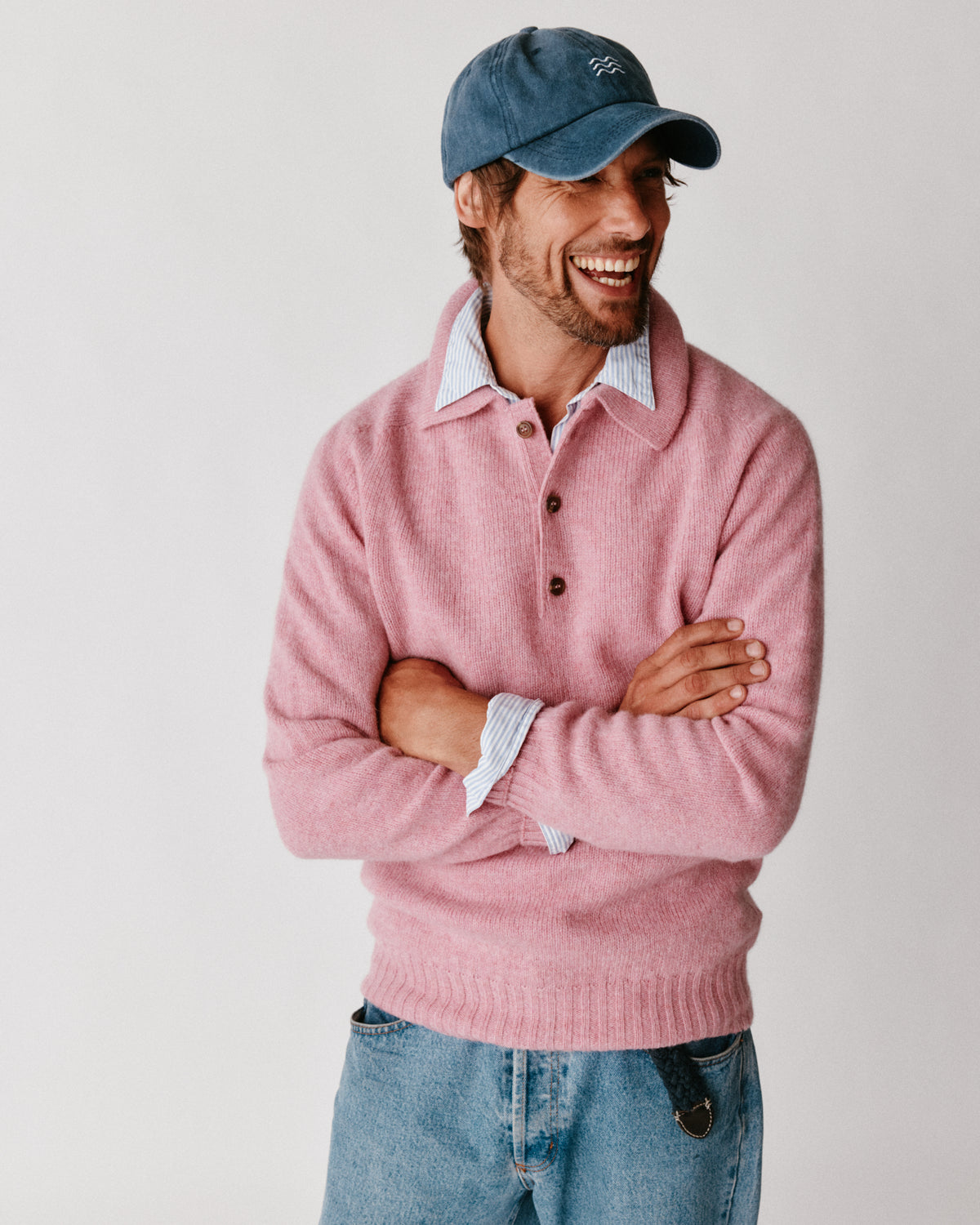 A model wearing a Bosie Harley of Scotland Mens Shetland Eton Collar Sweater in colour Sakura / Bosie Pink.