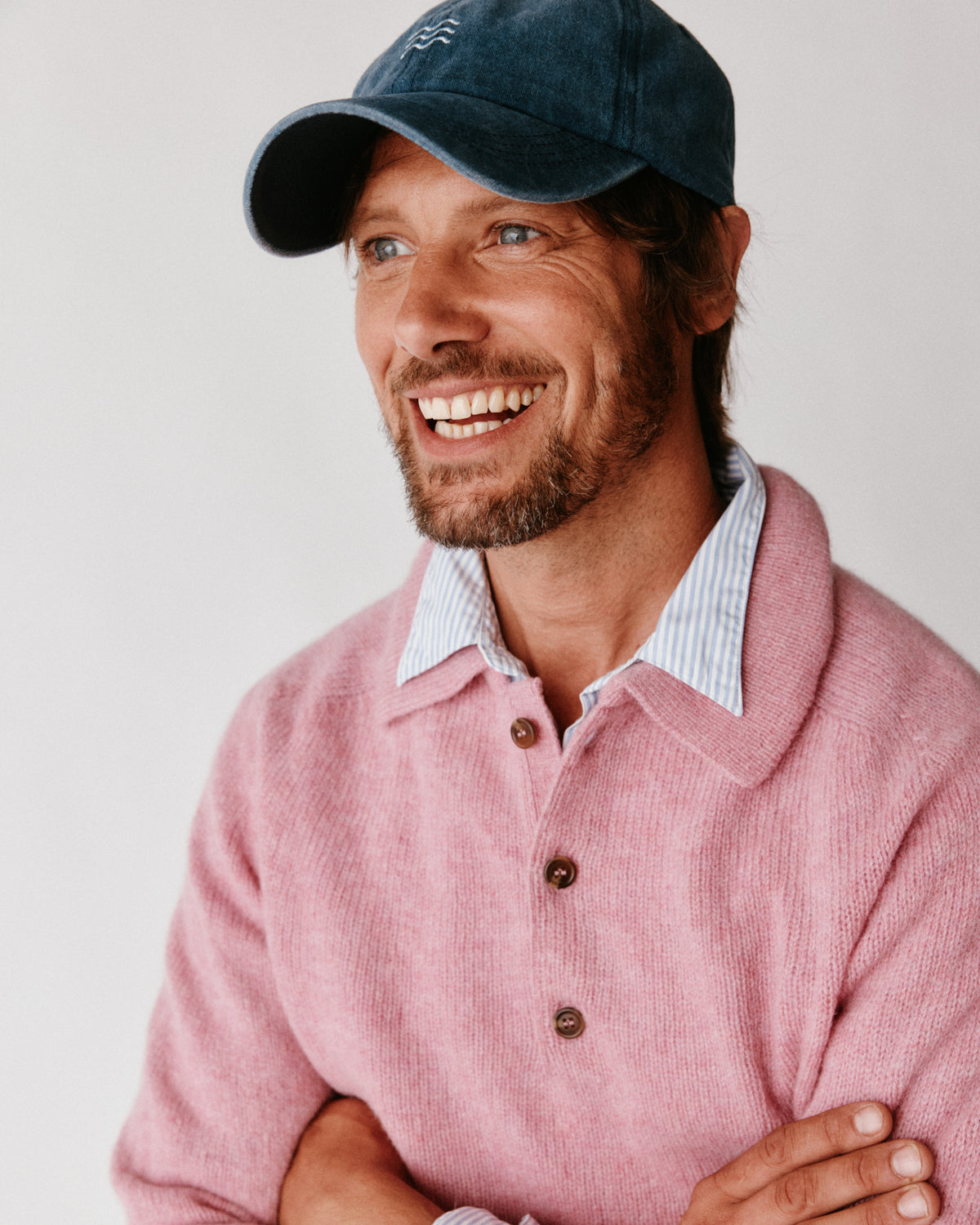 A model wearing a Bosie Harley of Scotland Mens Shetland Eton Collar Sweater in colour Sakura / Bosie Pink.