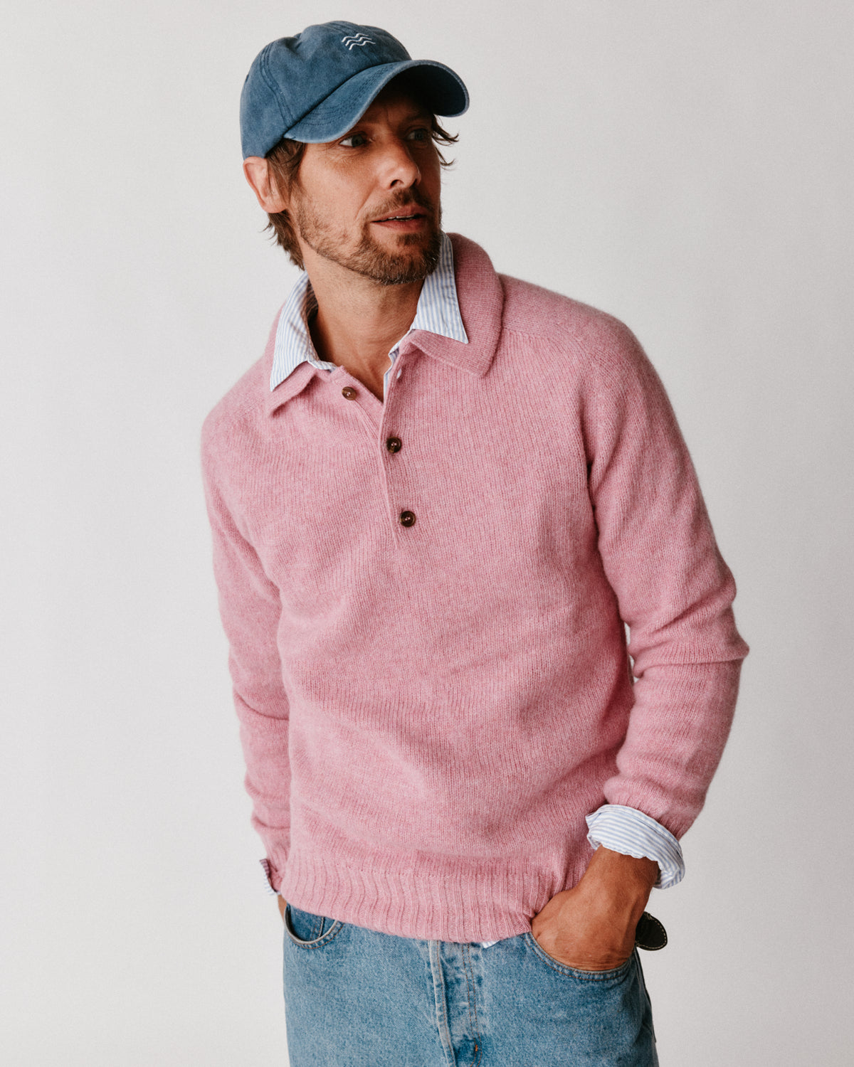 A model wearing a Bosie Harley of Scotland Mens Shetland Eton Collar Sweater in colour Sakura / Bosie Pink.