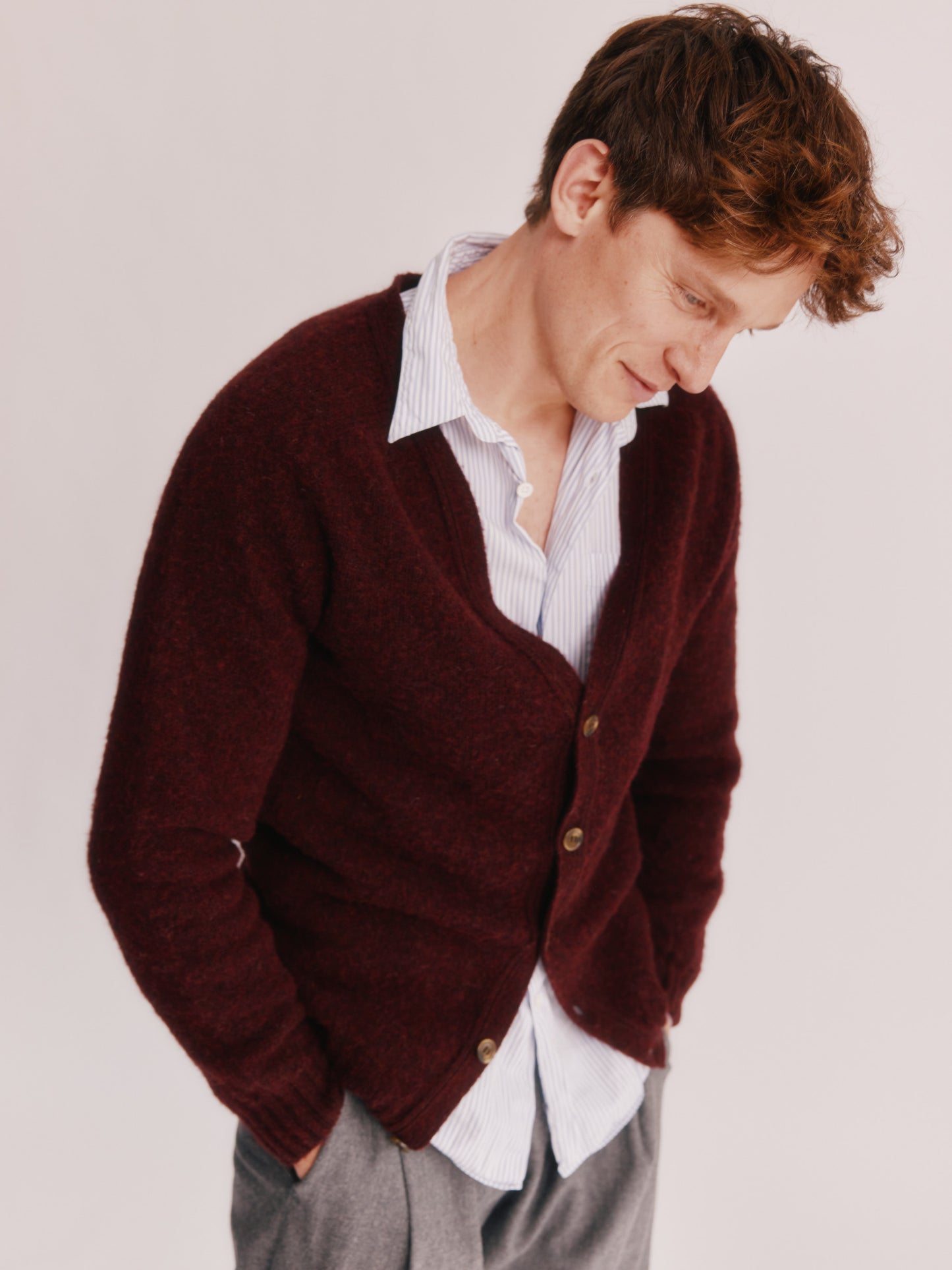 Model wearing a Bosie Knitwear Harley of Scotland Shaggy Shetland Men's V Cardigan in colour Dark Cranberry.