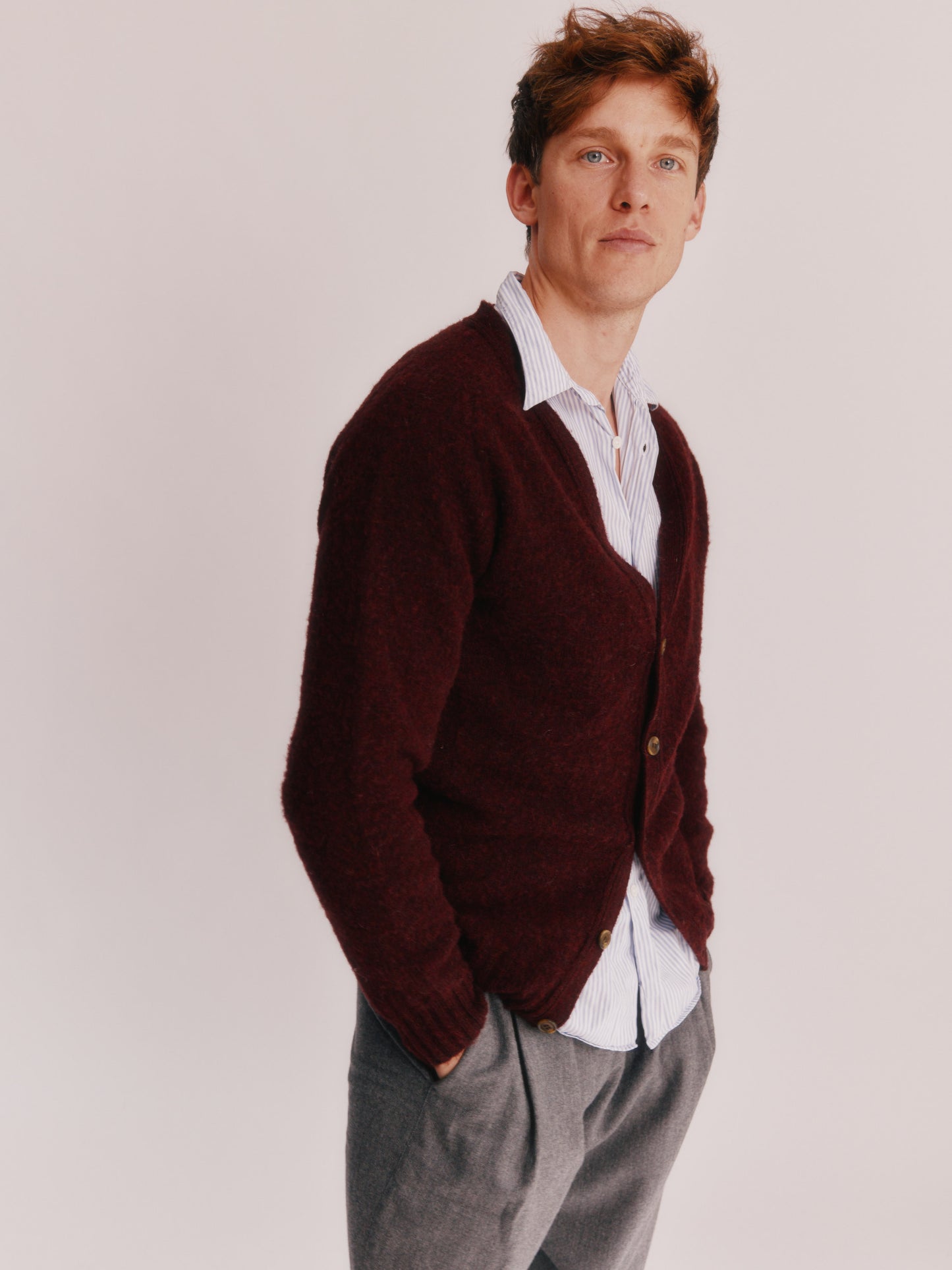 Model wearing a Bosie Knitwear Harley of Scotland Shaggy Shetland Men's V Cardigan in colour Dark Cranberry.