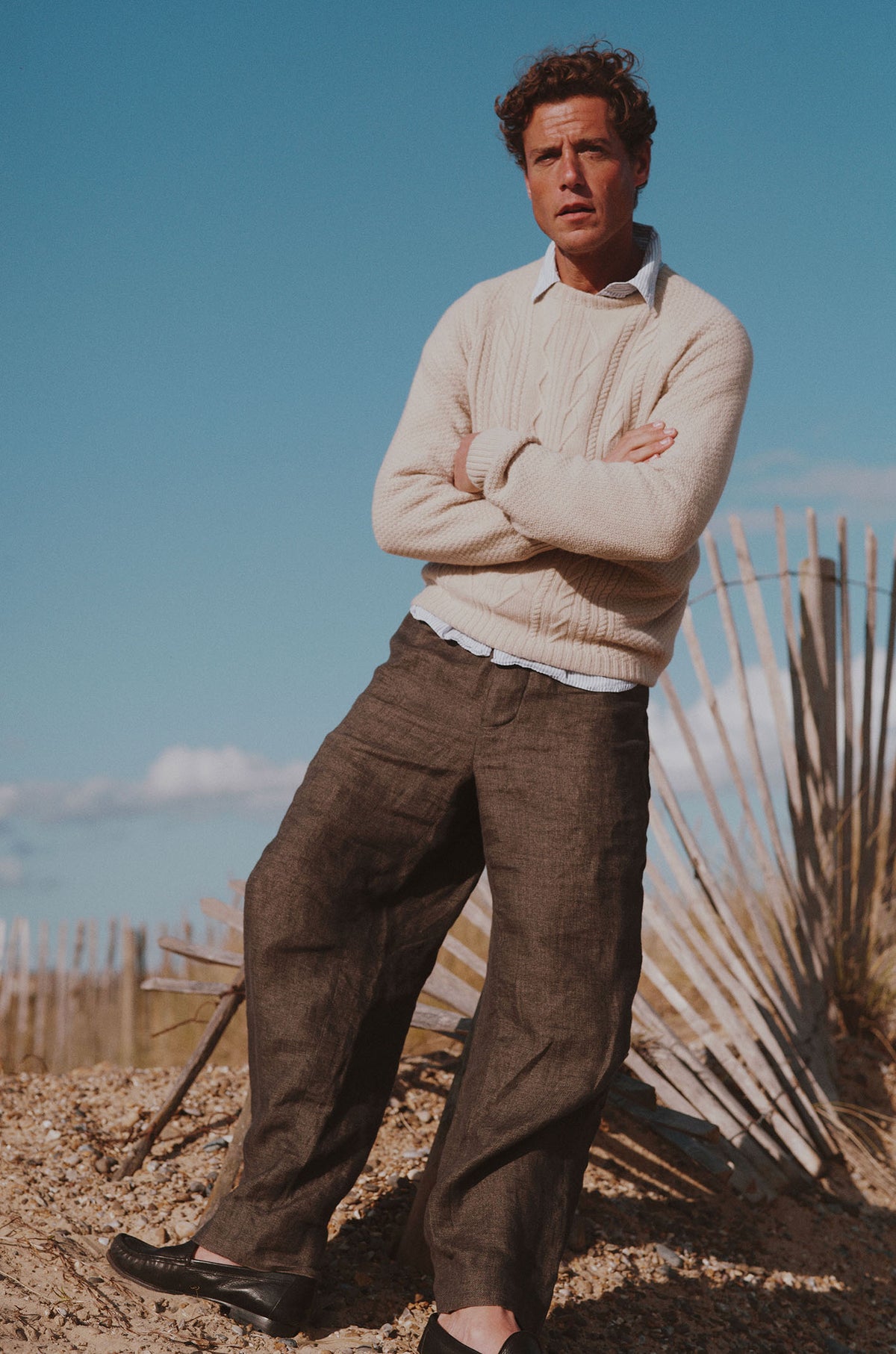 Man on a beach wearing a Bosie Knitwear Harley x Todd and Duncan Pure Cashmere Cable Sweater