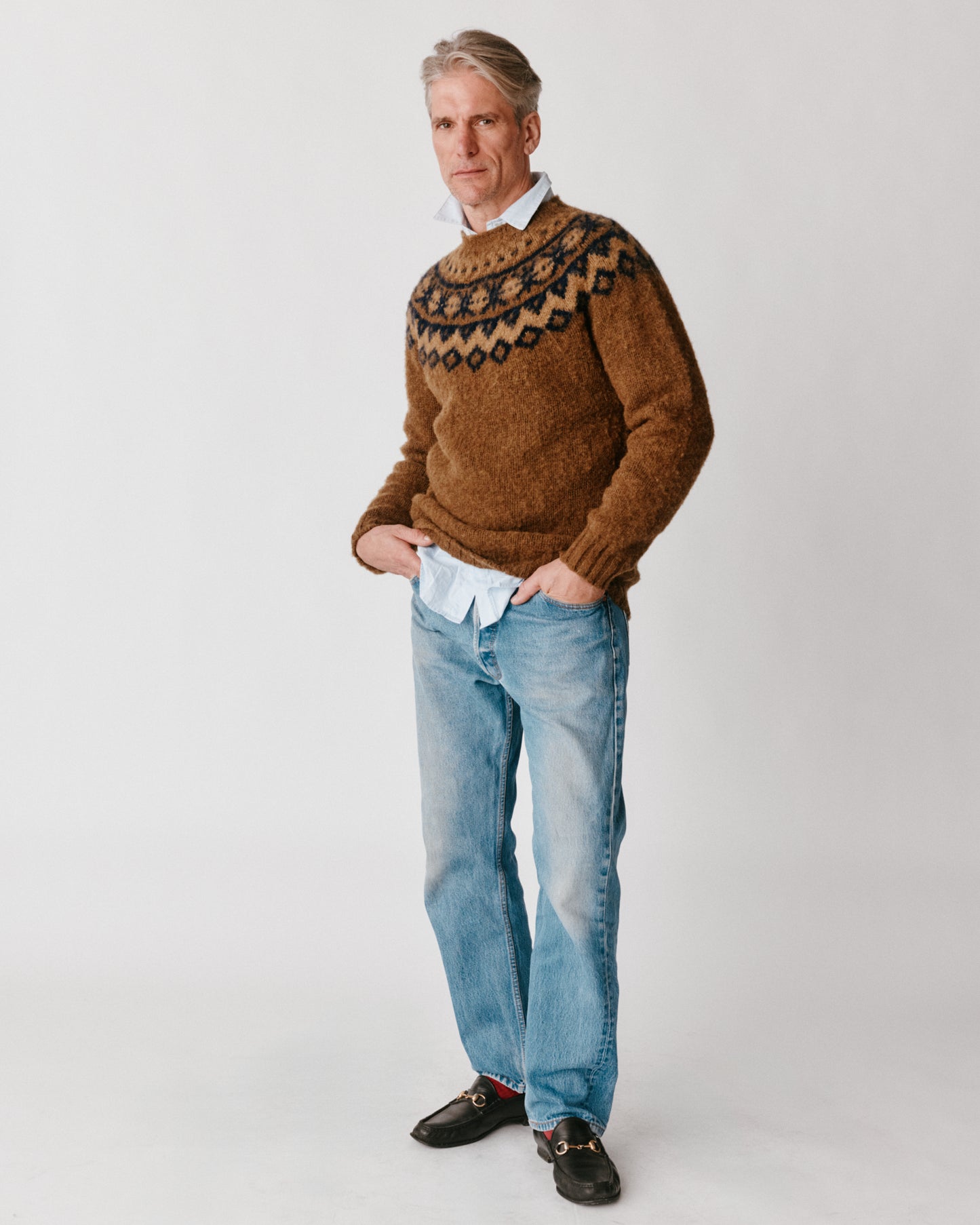 A model wearing a Bosie Highland Brushed Fairisle Yoke Lambswool Sweater in colour Moorland / Dark Olive.