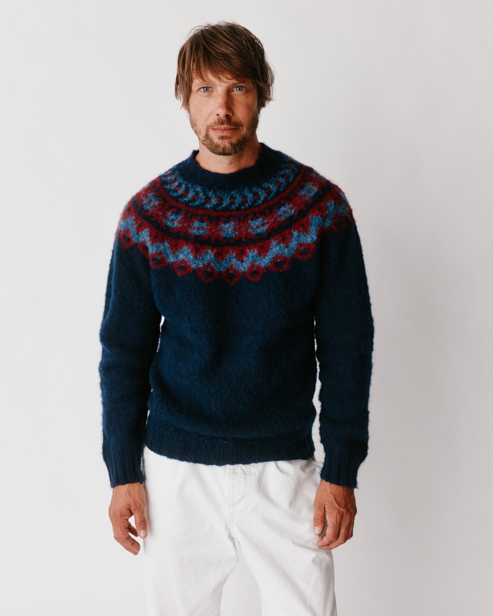 A model wearing a Bosie Highland Brushed Fairisle Yoke Lambswool Sweater in colour Navy.