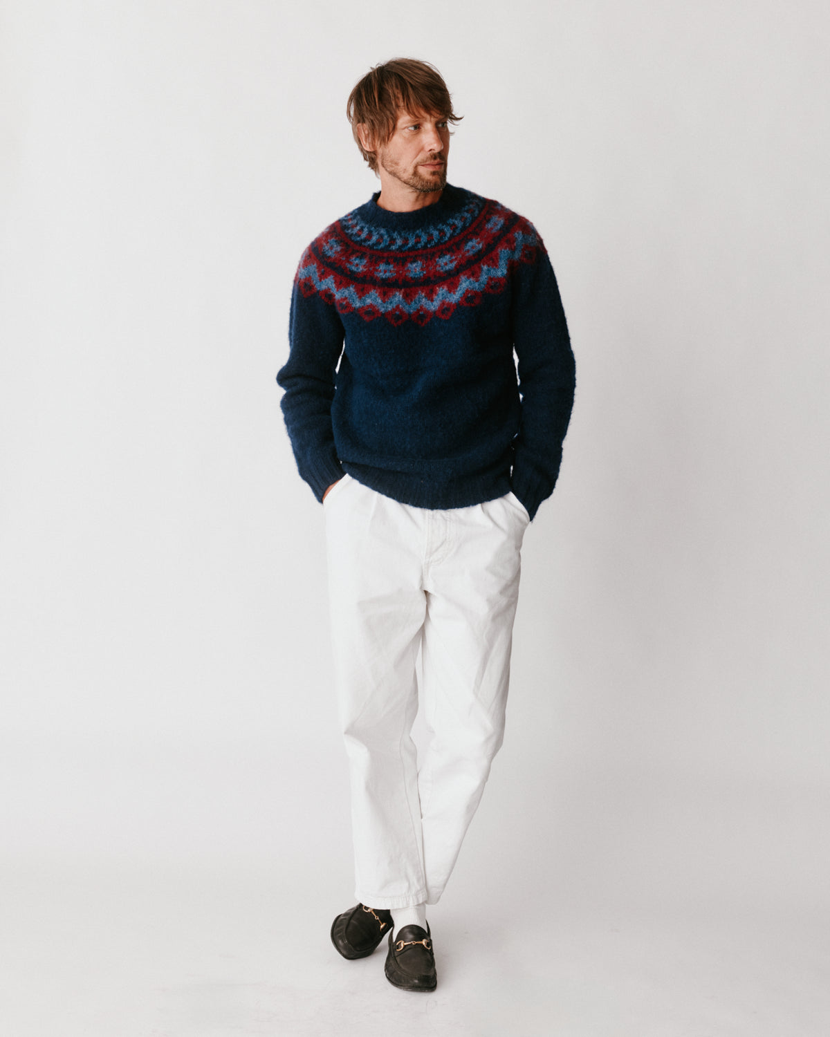 A model wearing a Bosie Highland Brushed Fairisle Yoke Lambswool Sweater in colour Navy.