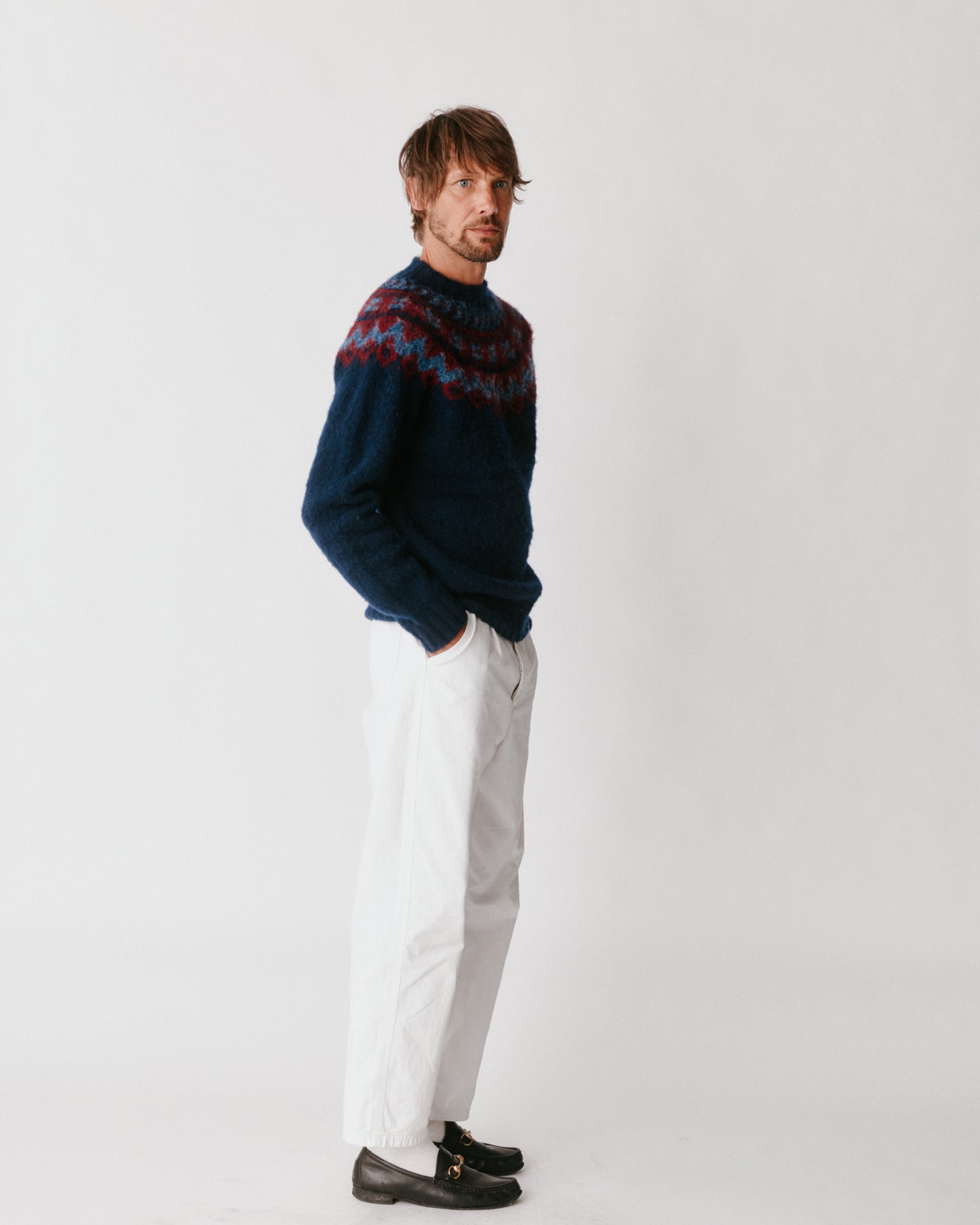 A model wearing a Bosie Highland Brushed Fairisle Yoke Lambswool Sweater in colour Navy.