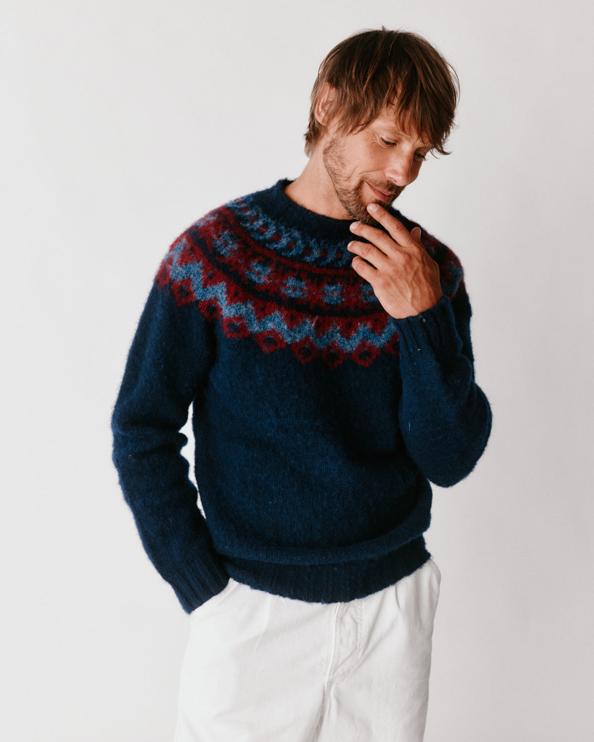 A model wearing a Bosie Highland Brushed Fairisle Yoke Lambswool Sweater in colour Navy.