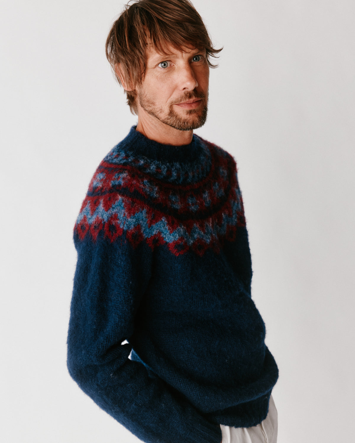 A model wearing a Bosie Highland Brushed Fairisle Yoke Lambswool Sweater in colour Navy.