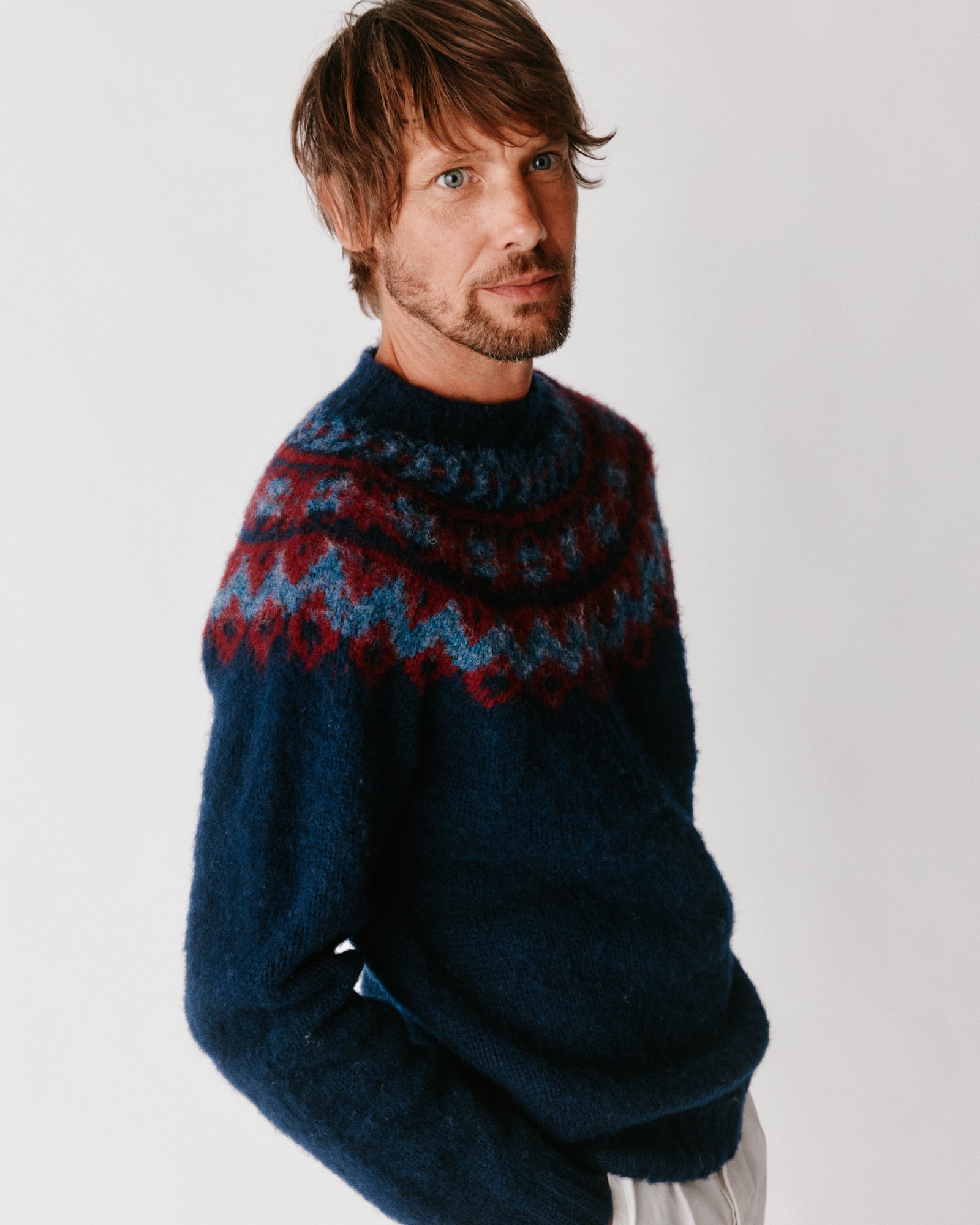 A model wearing a Bosie Highland Brushed Fairisle Yoke Lambswool Sweater in colour Navy.