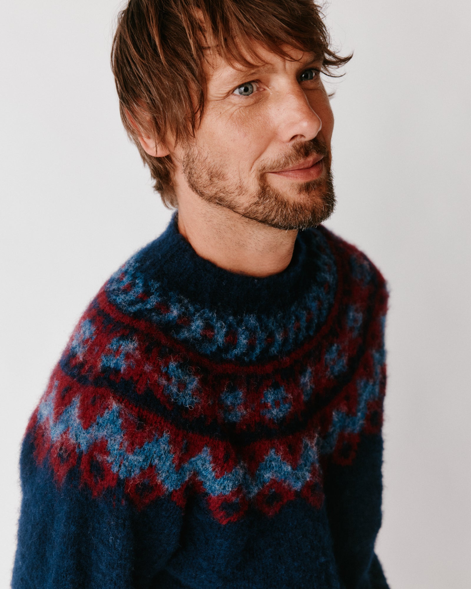  A model wearing a Bosie Highland Brushed Fairisle Yoke Lambswool Sweater in colour Navy.
