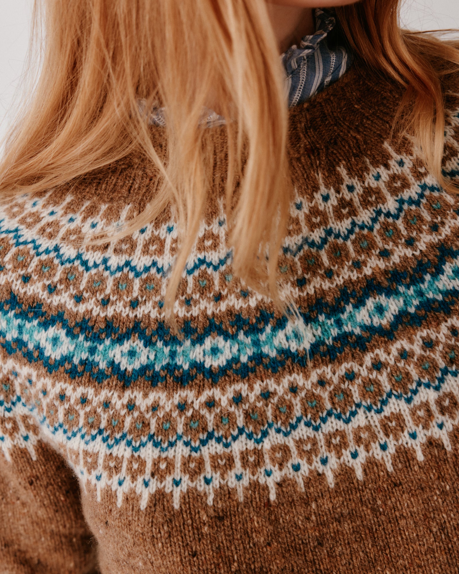 A model wearing a Bosie Islander Yoke Fair Isle Glenugie Nep Women's Sweater in colour Knoydart.