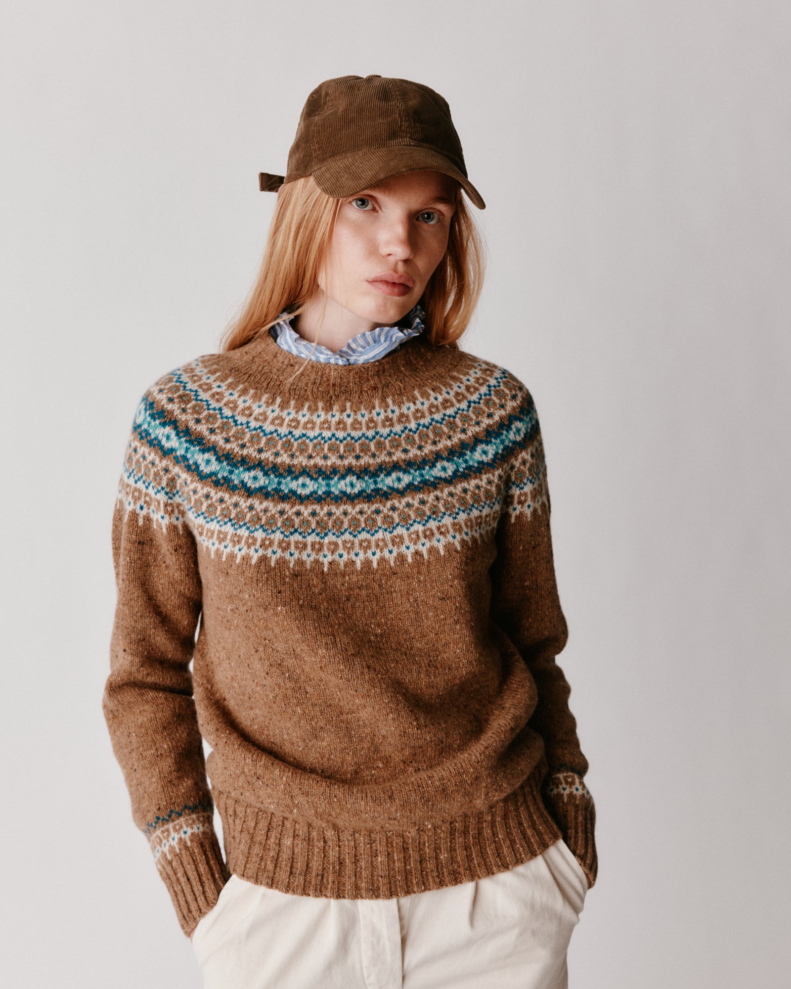 A model wearing a Bosie Islander Yoke Fair Isle Glenugie Nep Women's Sweater in colour Knoydart.