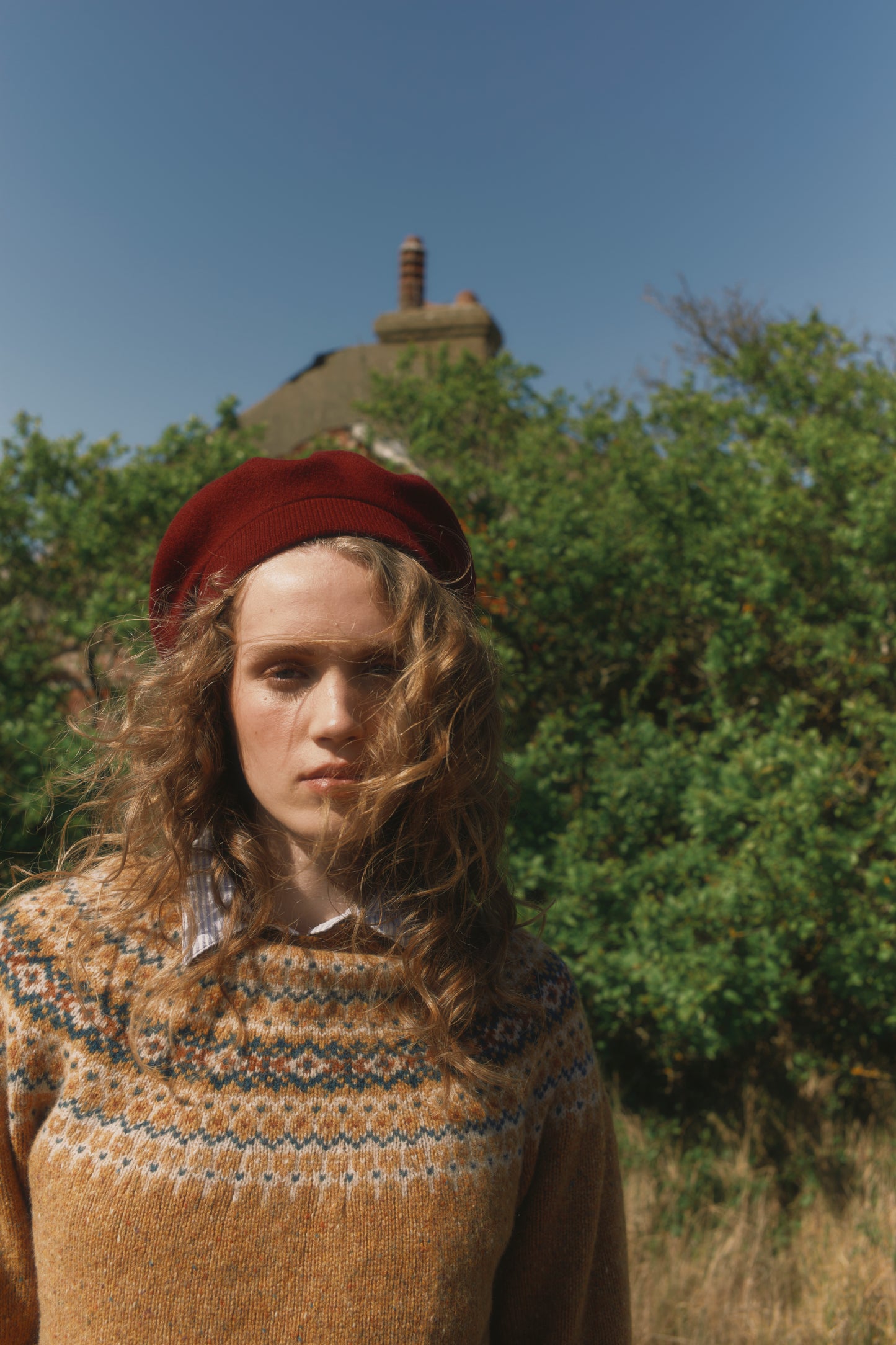 Model wearing a Bosie Knitwear Islander Yoke Fair Isle Glenugie Nep Women's Sweater in colour Barra Gold.