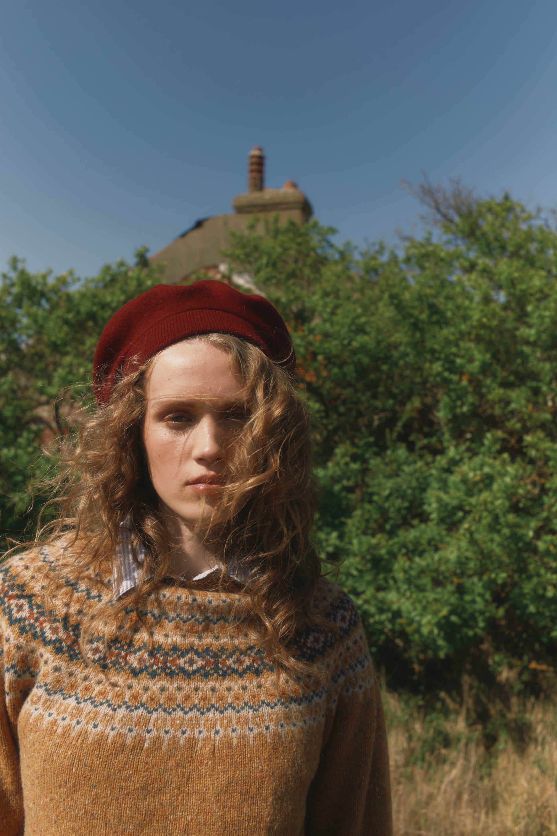 Model wearing a Bosie Knitwear Islander Yoke Fair Isle Glenugie Nep Women's Sweater in colour Barra Gold.