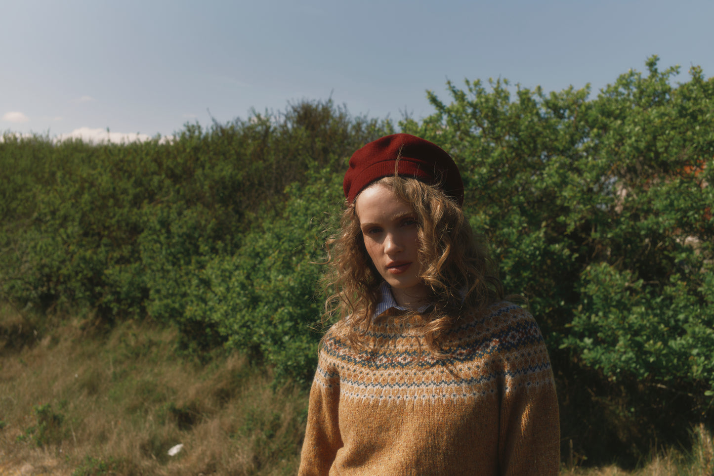 Model wearing a Bosie Knitwear Islander Yoke Fair Isle Glenugie Nep Women's Sweater in colour Barra Gold.