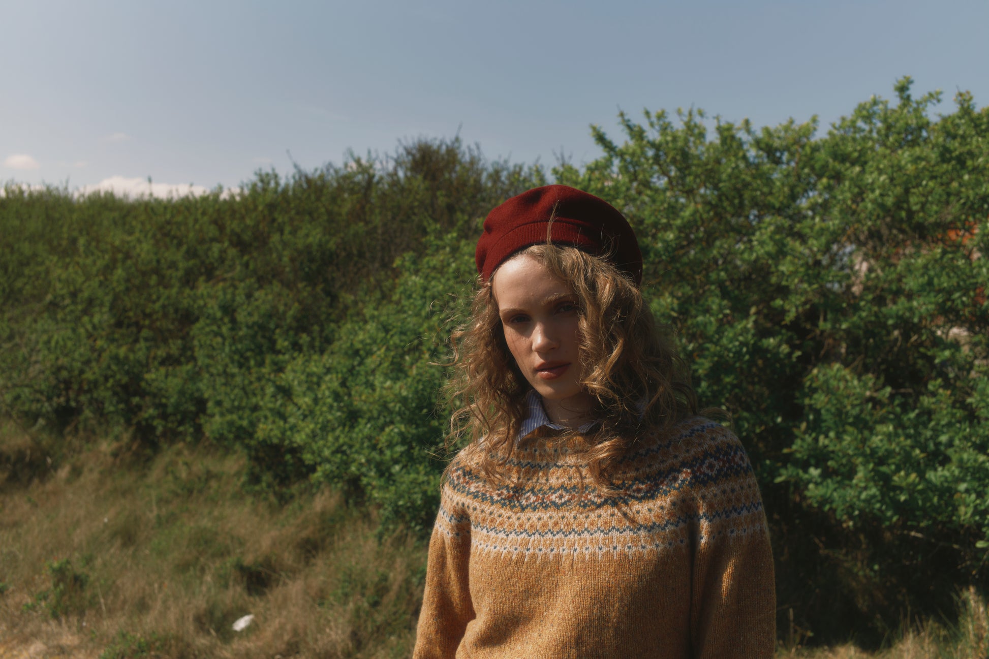 Model wearing a Bosie Knitwear Islander Yoke Fair Isle Glenugie Nep Women's Sweater in colour Barra Gold.