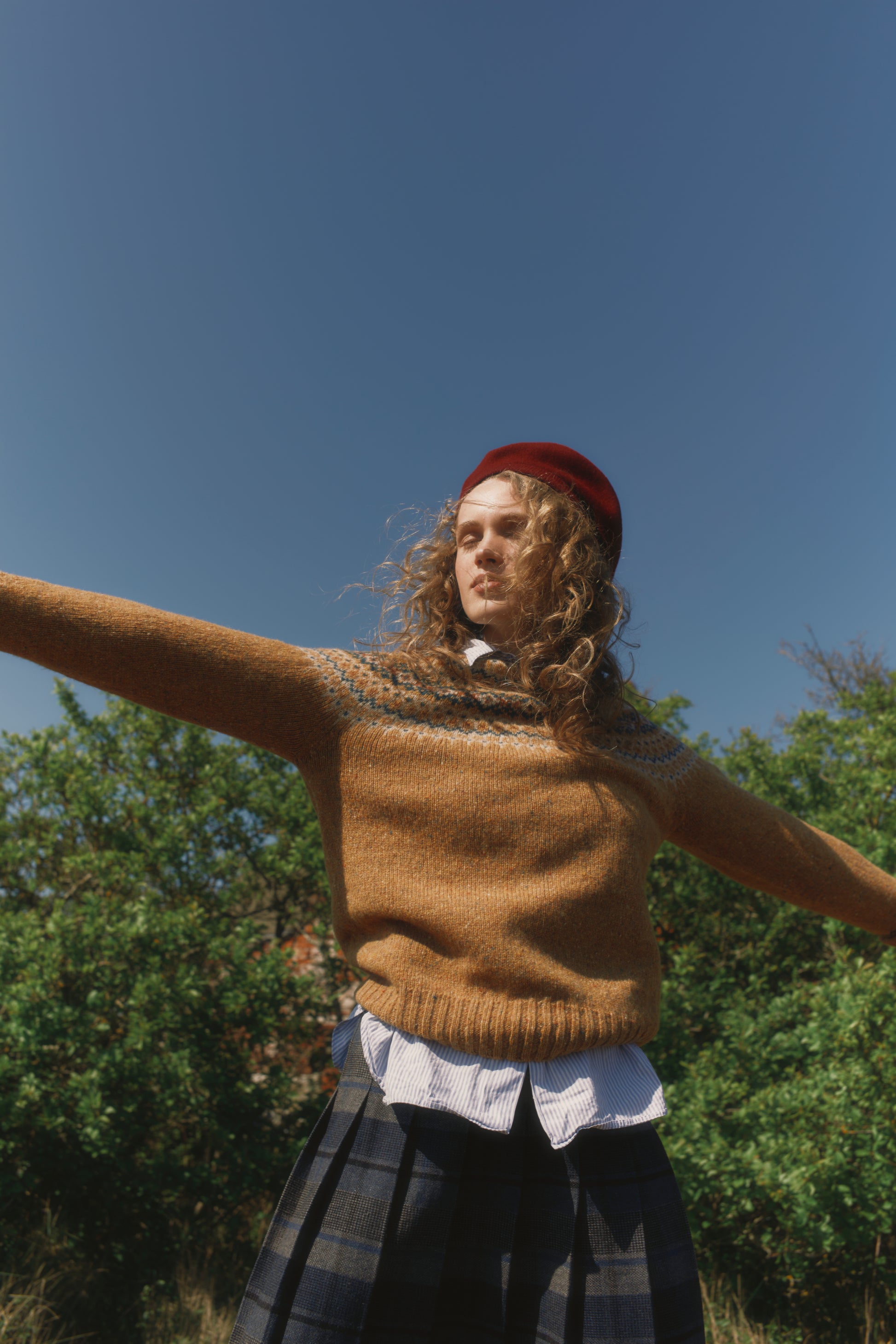 Model wearing a Bosie Knitwear Islander Yoke Fair Isle Glenugie Nep Women's Sweater in colour Barra Gold.