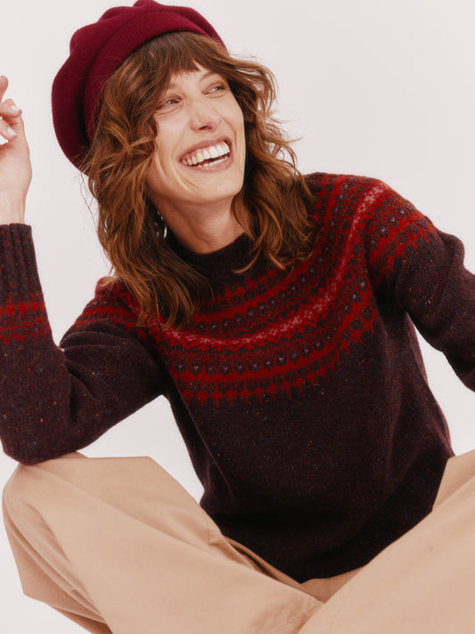 Model wearing a Bosie Knitwear Islander Yoke Fair Isle Glenugie Nep Women's Sweater in colour Lewis Dark Aubergine.