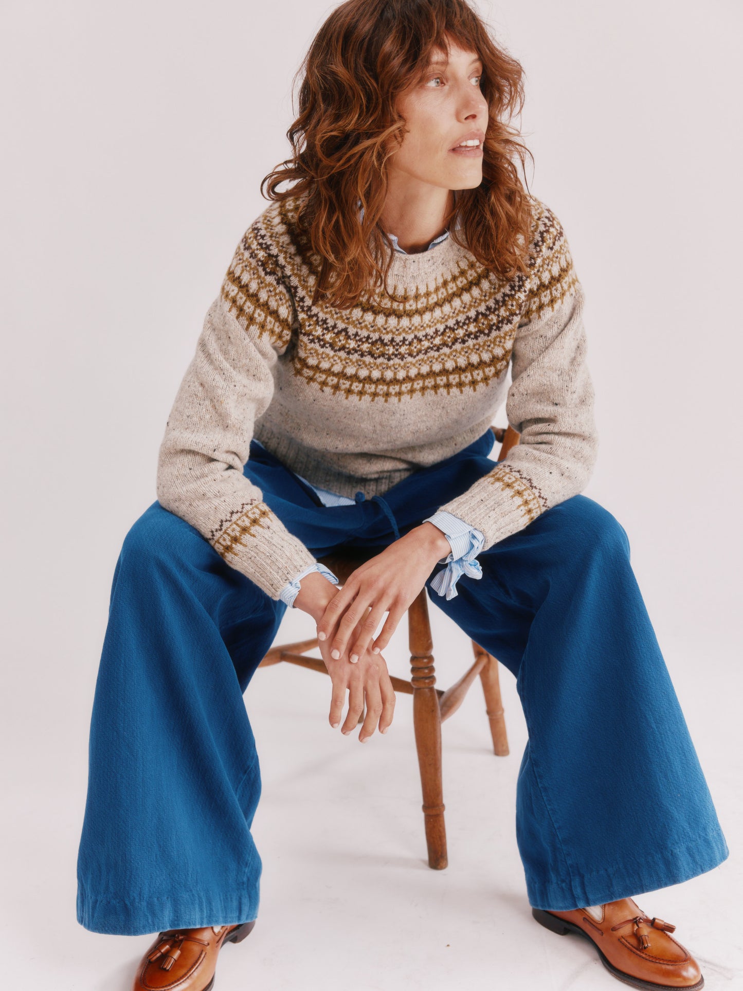 Model wearing a Bosie Knitwear Islander Yoke Fair Isle Glenugie Nep Women's Sweater in colour Mull Natural.