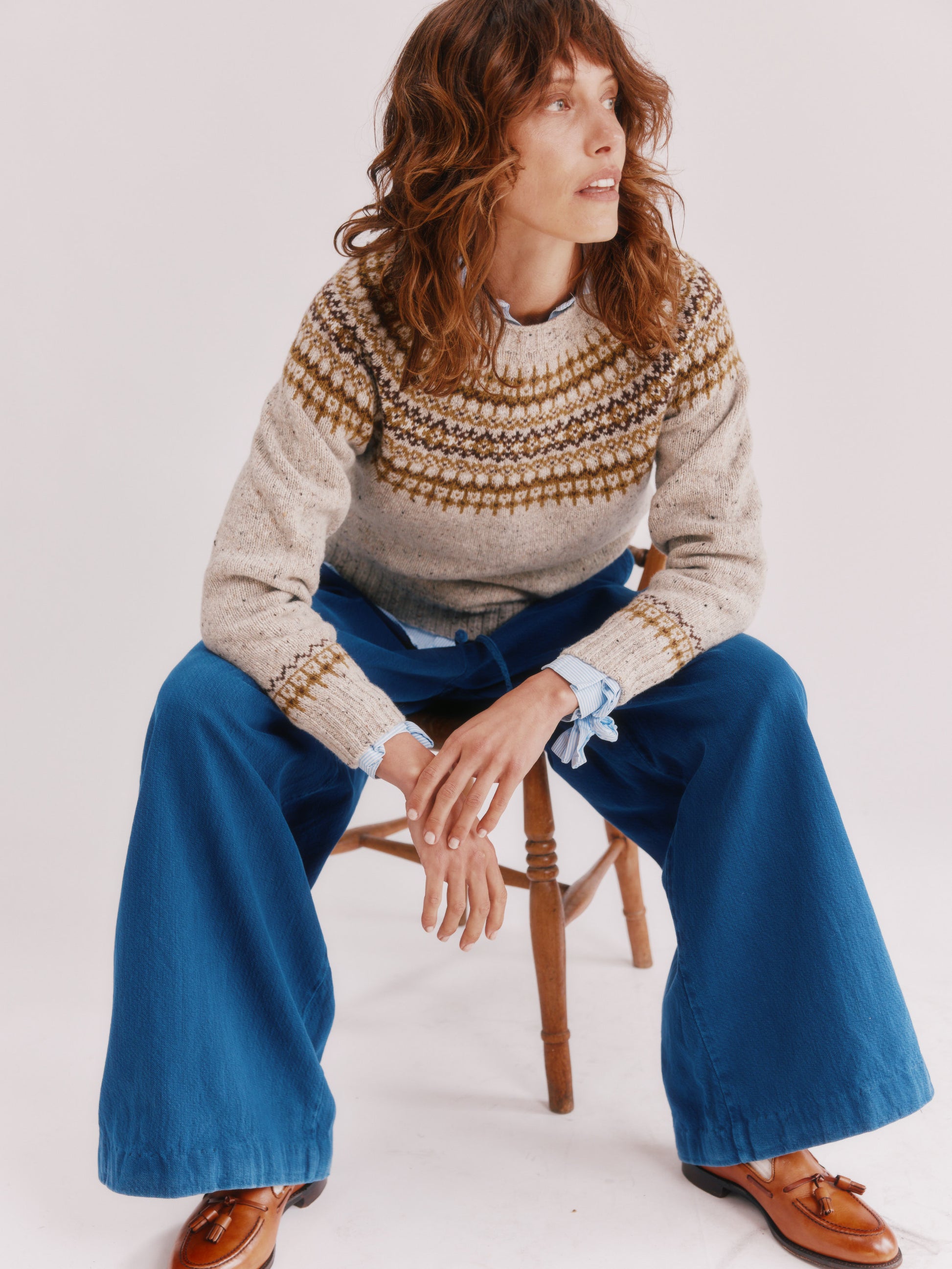 Model wearing a Bosie Knitwear Islander Yoke Fair Isle Glenugie Nep Women's Sweater in colour Mull Natural.