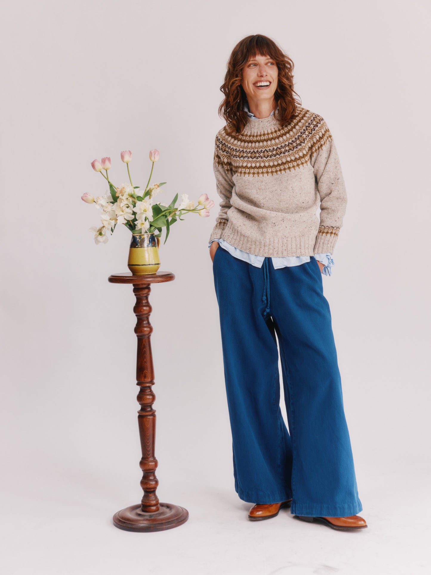 Model wearing a Bosie Knitwear Islander Yoke Fair Isle Glenugie Nep Women's Sweater in colour Mull Natural.