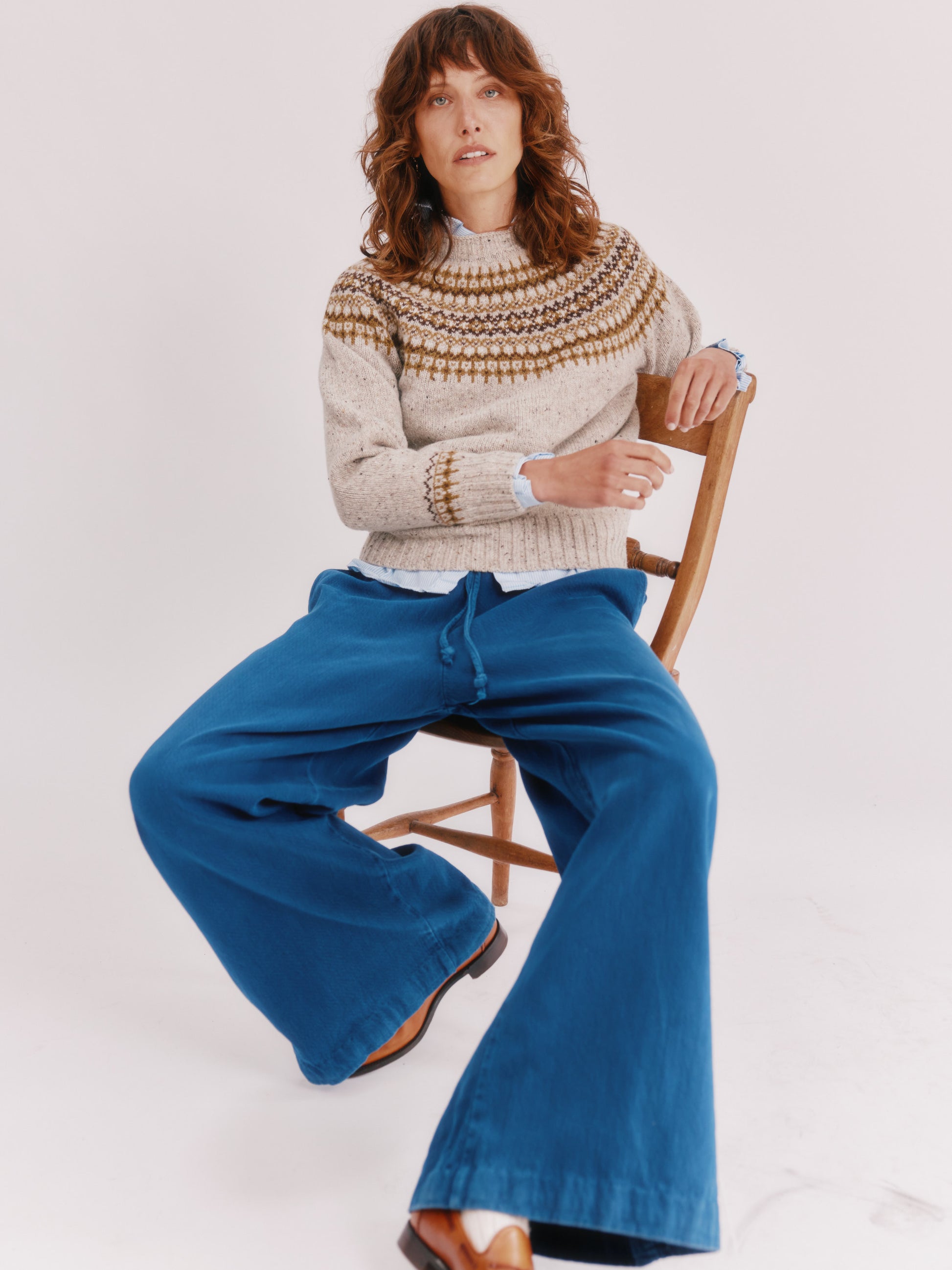 Model wearing a Bosie Knitwear Islander Yoke Fair Isle Glenugie Nep Women's Sweater in colour Mull Natural.