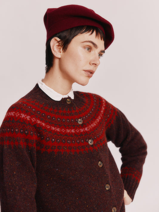 Model wearing a Bosie Knitwear Islander Yoke Fair Isle Glenugie Women's Cardigan in colour Lewis Dark Aubergine.