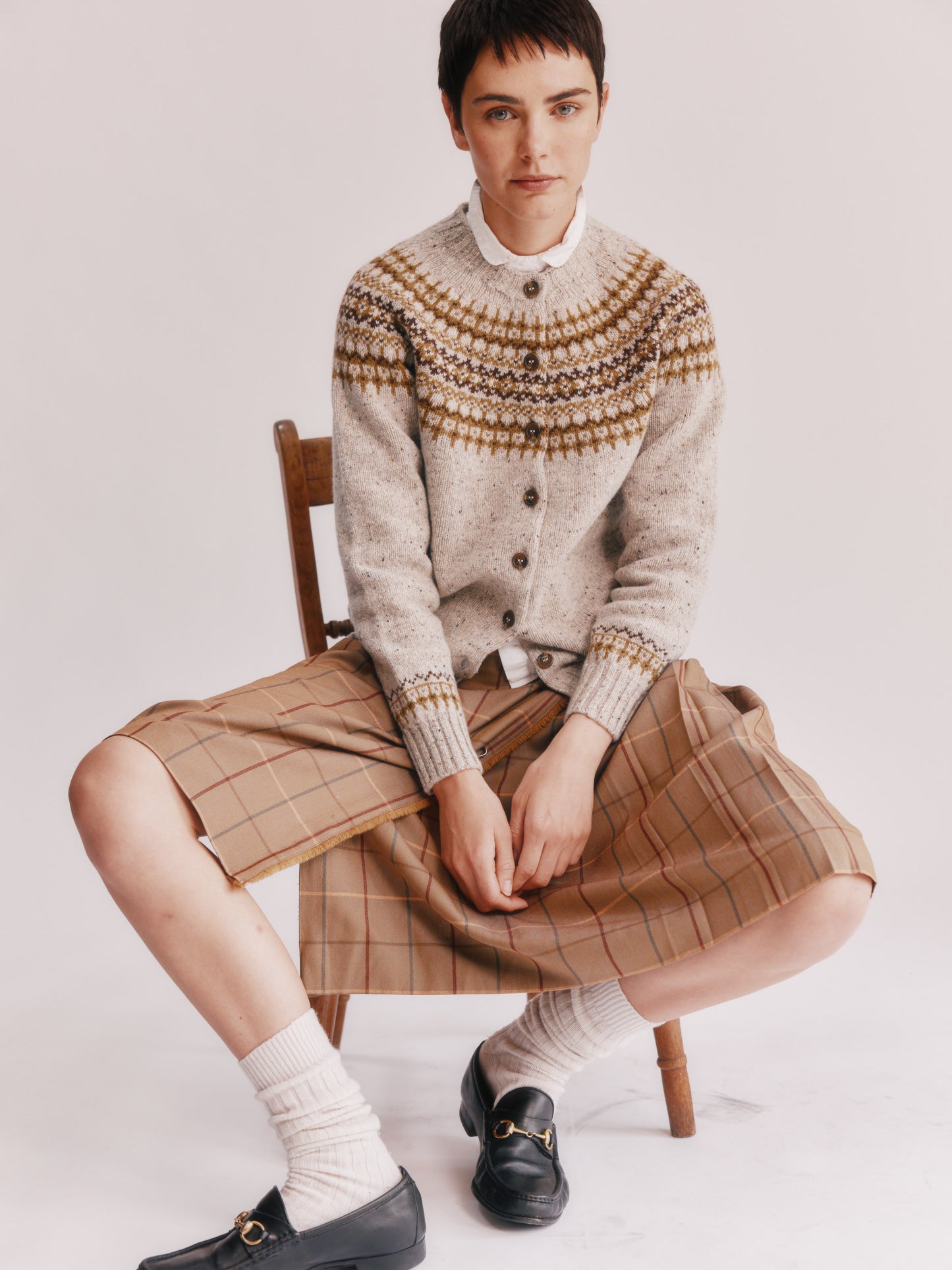 Model wearing a Bosie Knitwear Islander Yoke Fair Isle Glenugie Women's Cardigan in colour Mull Natural.
