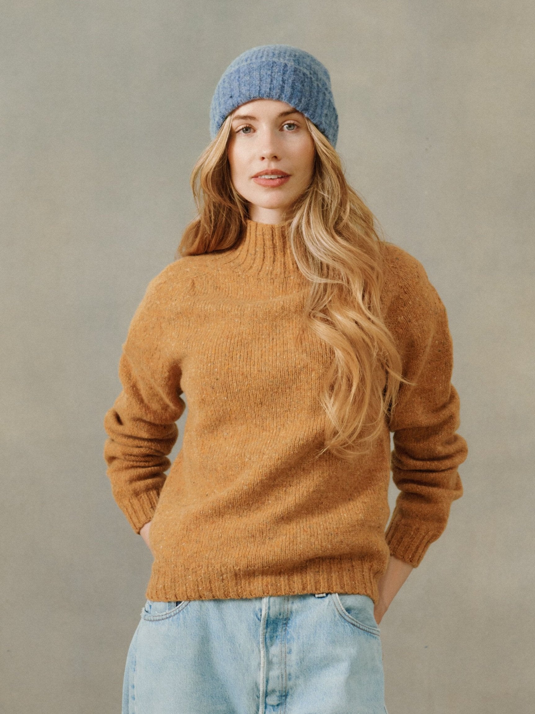 Woman wearing a Bosie women's Glenugie Nep Kintyre funnel neck sweater jumper in Barra Gold