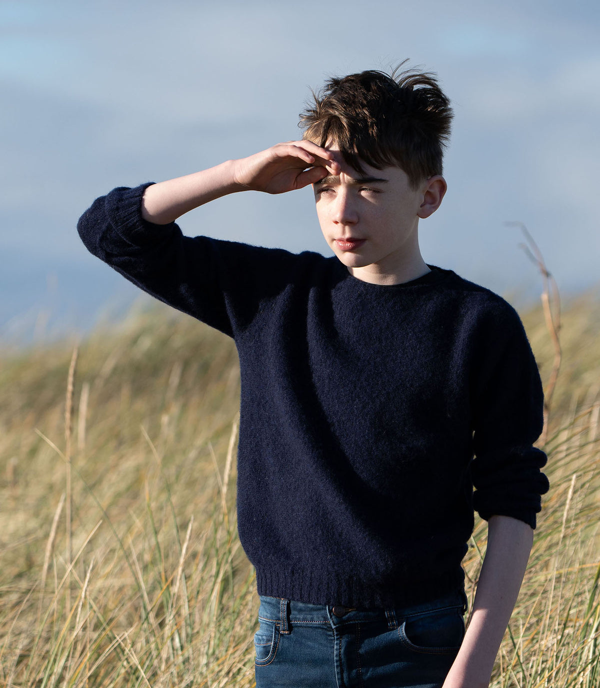 A boy in a Bosie Little Bosie Childs Brushed Wool Island Shetland Sweater -in colour Navy.