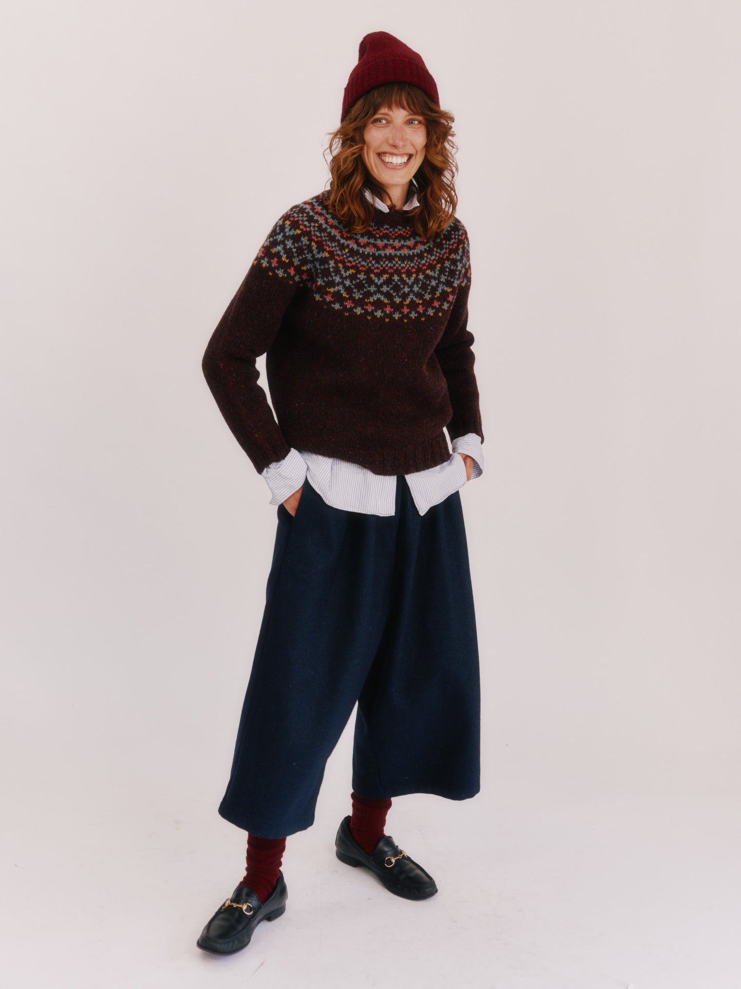 Model wearing a Bosie Knitwear Luskentyre Chunky Fair Isle Glenugie Nep Women's Sweater in colour Lewis Dark Aubergine.