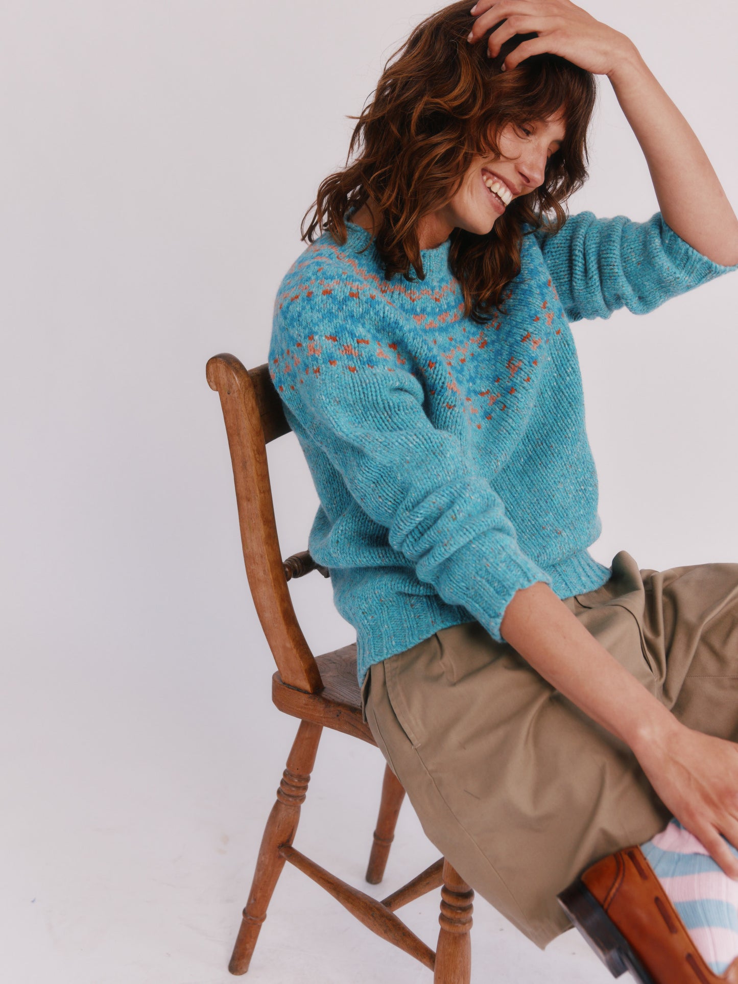 Model wearing a Bosie Knitwear Luskentyre Chunky Fair Isle Glenugie Nep Women's Sweater in colour Uist Blue.