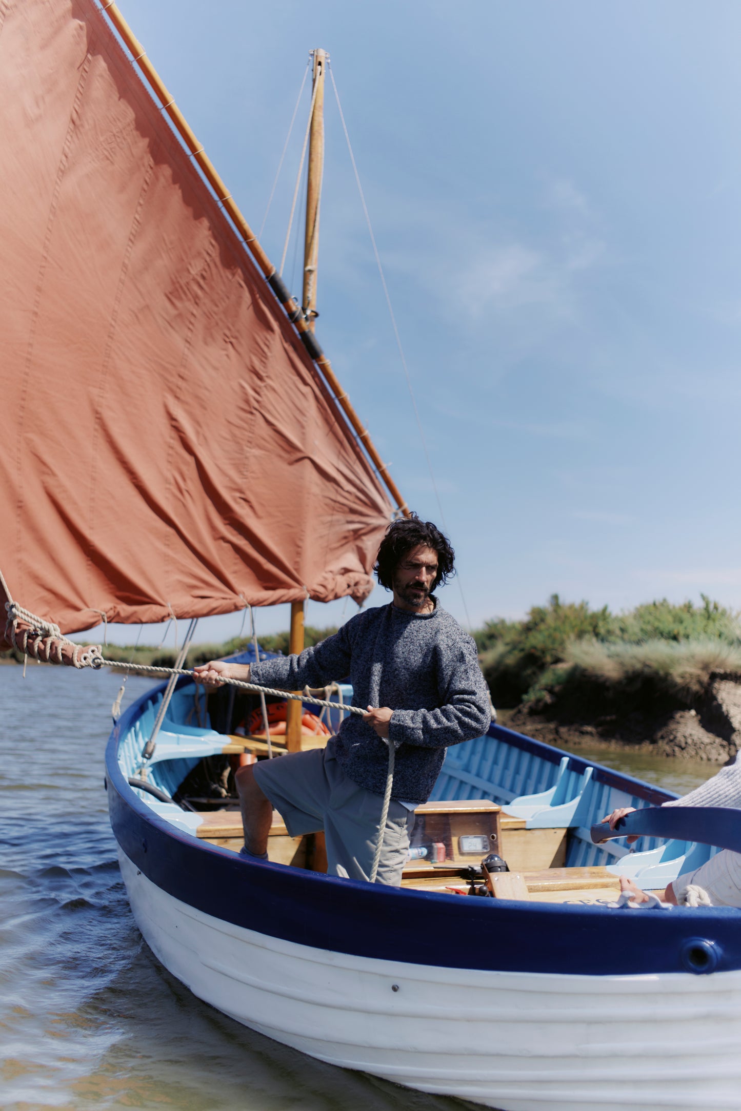 Man on boat wearing a Bosie Knitwear Blue Mogganer Whaler Sweater