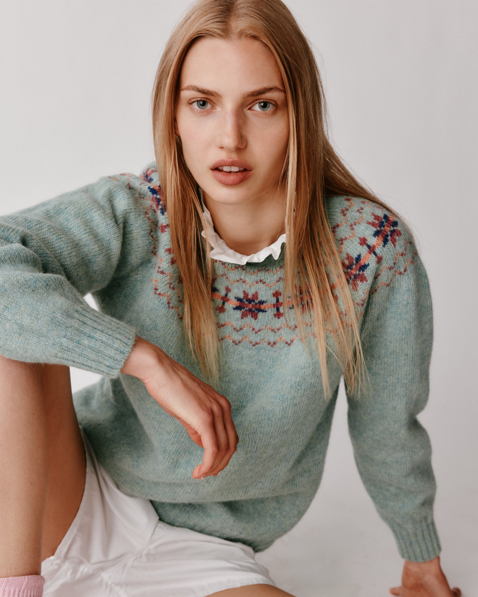 A model wearing a Bosie Murron Yoke Fair Isle Women's Sweater in colour Fauna/Opal.