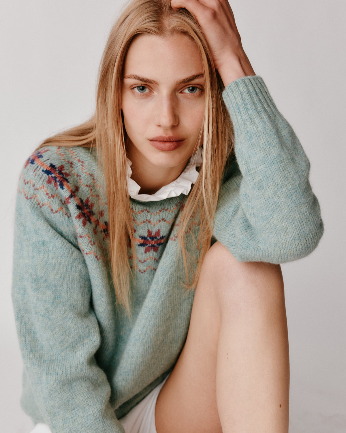 A model wearing a Bosie Murron Yoke Fair Isle Women's Sweater in colour Fauna/Opal.