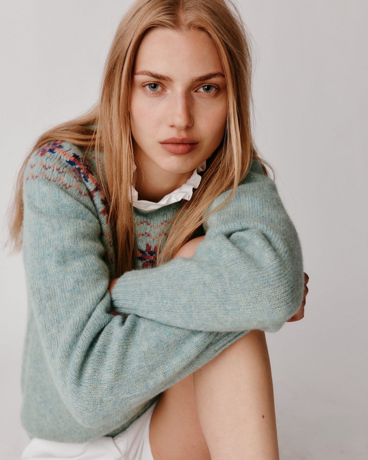 A model wearing a Bosie Murron Yoke Fair Isle Women's Sweater in colour Fauna/Opal.