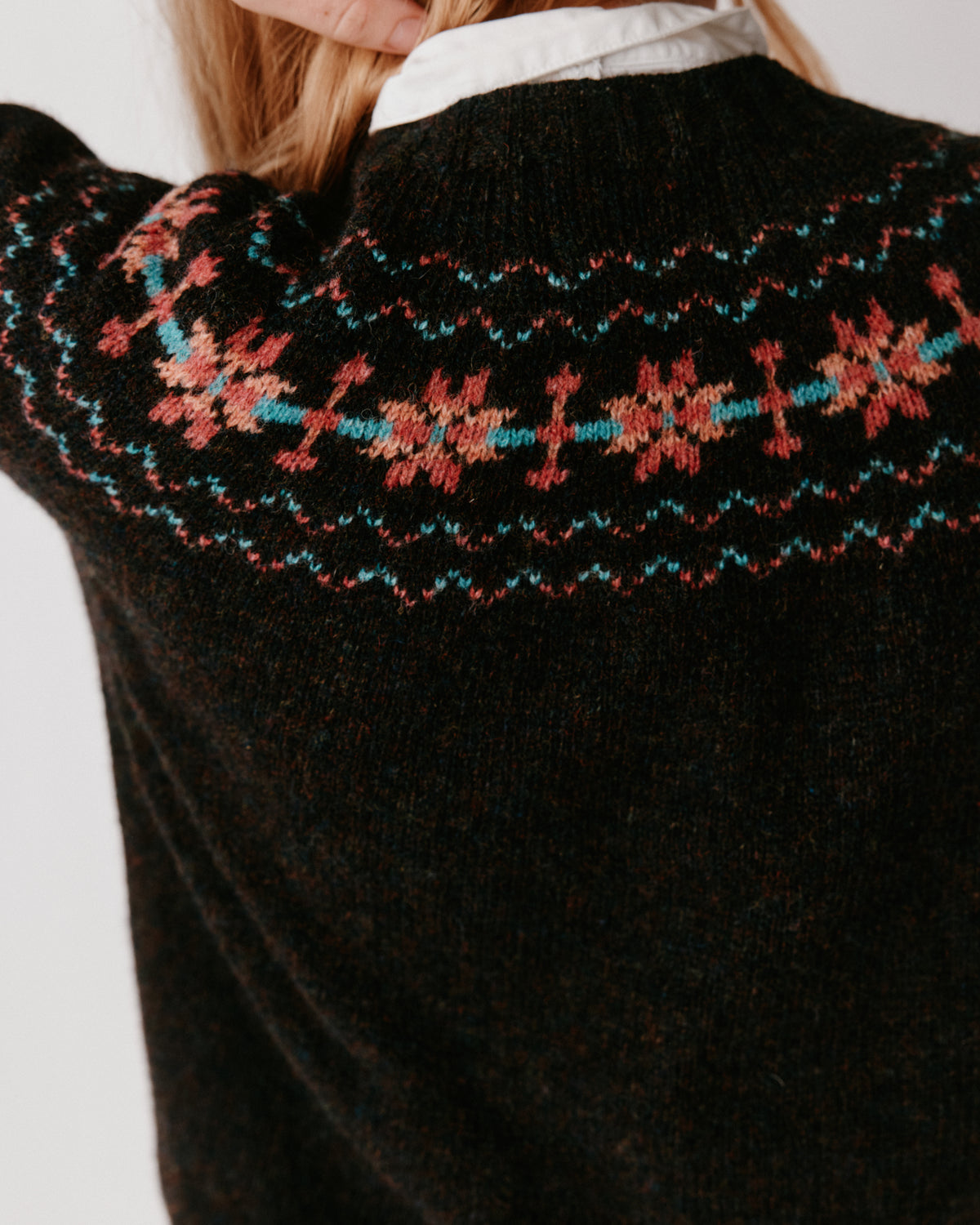 A model wearing a Bosie Murron Yoke Fair Isle Women's Sweater in colour Volcano/Midnight.