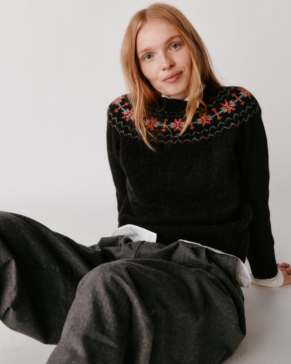 A model wearing a Bosie Murron Yoke Fair Isle Womens Sweater in colour Volcano/Midnight.