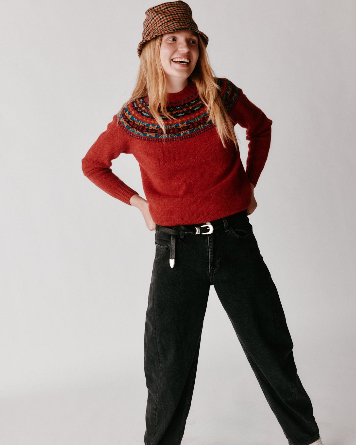 A model wearing a Bosie Skye Yoke Fair Isle Women's Sweater in colour Framboise.