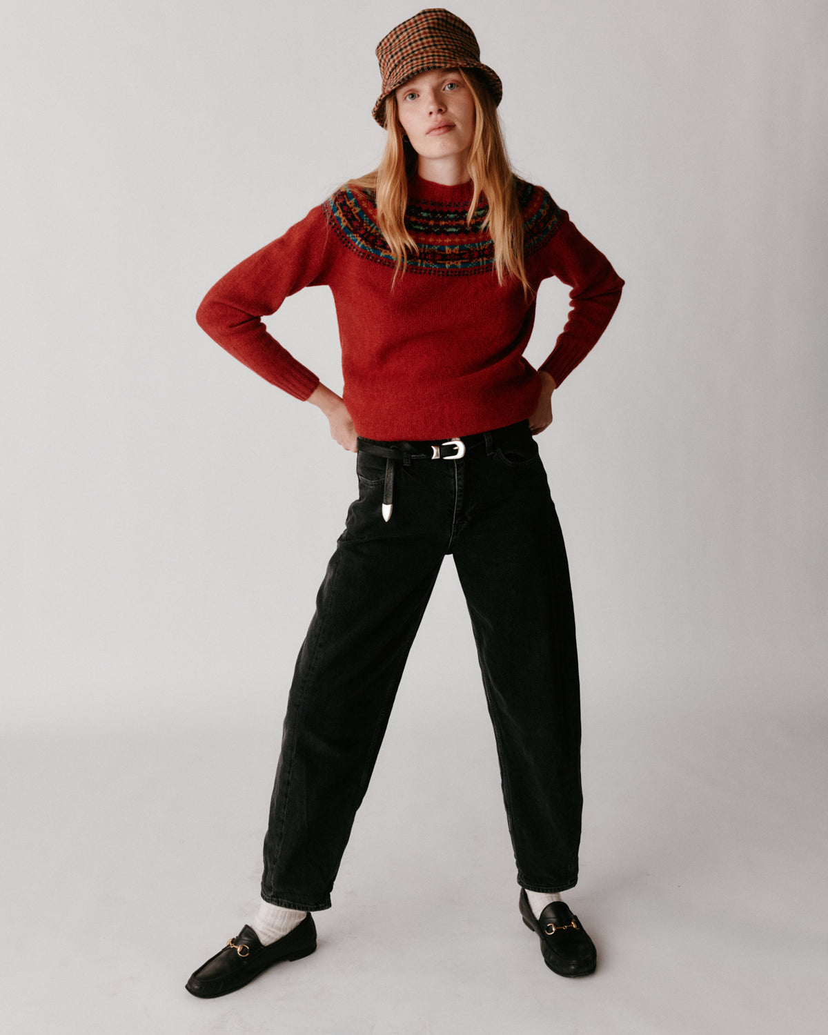 A model wearing a Bosie Skye Yoke Fair Isle Women's Sweater in colour Framboise.